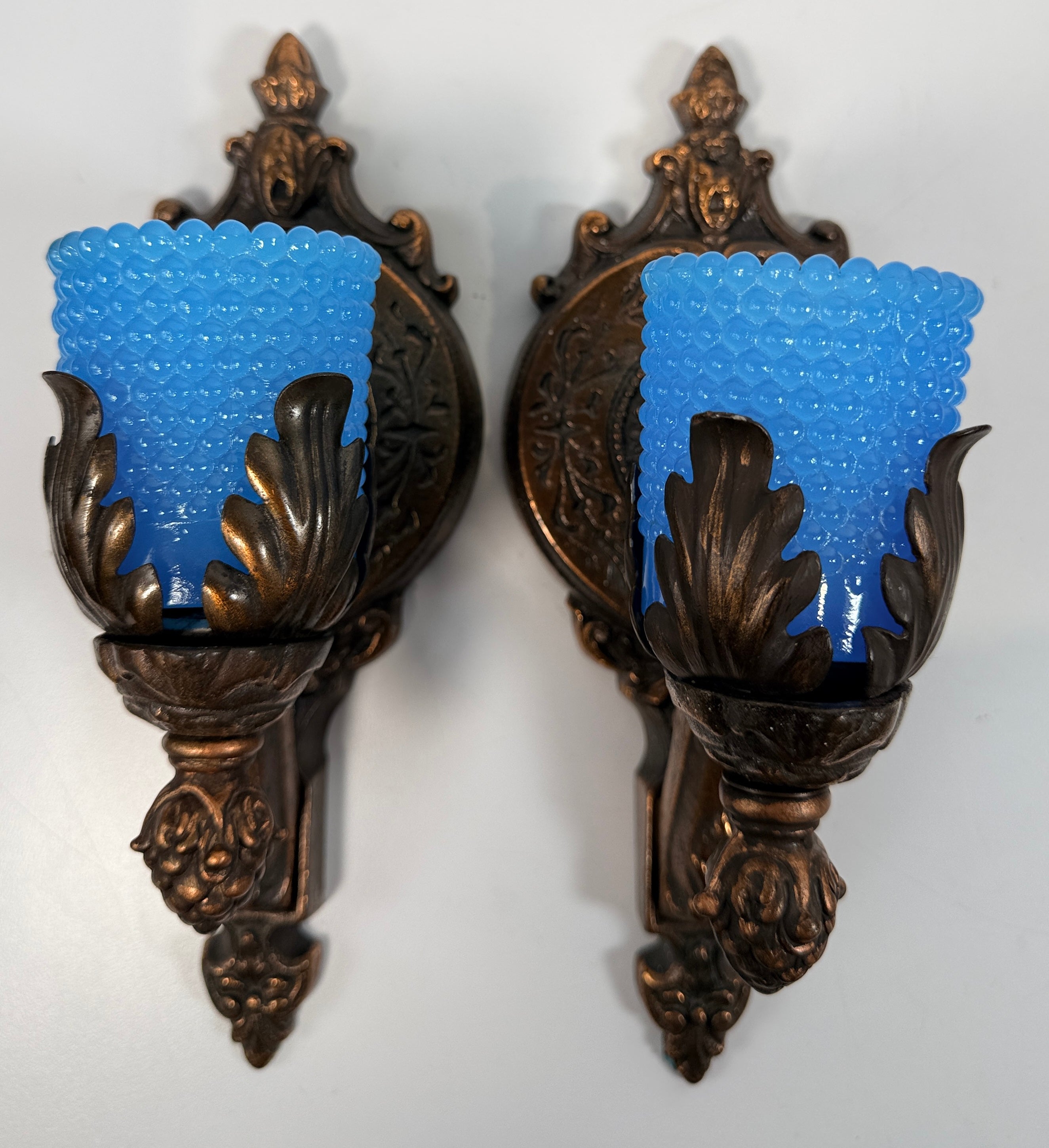 Vintage Hollywood Regency wall sconces pair with gold leaf finish and blue hobnail glass shades. Ornate cast metal accent lighting, 9.5 inch set of 2.