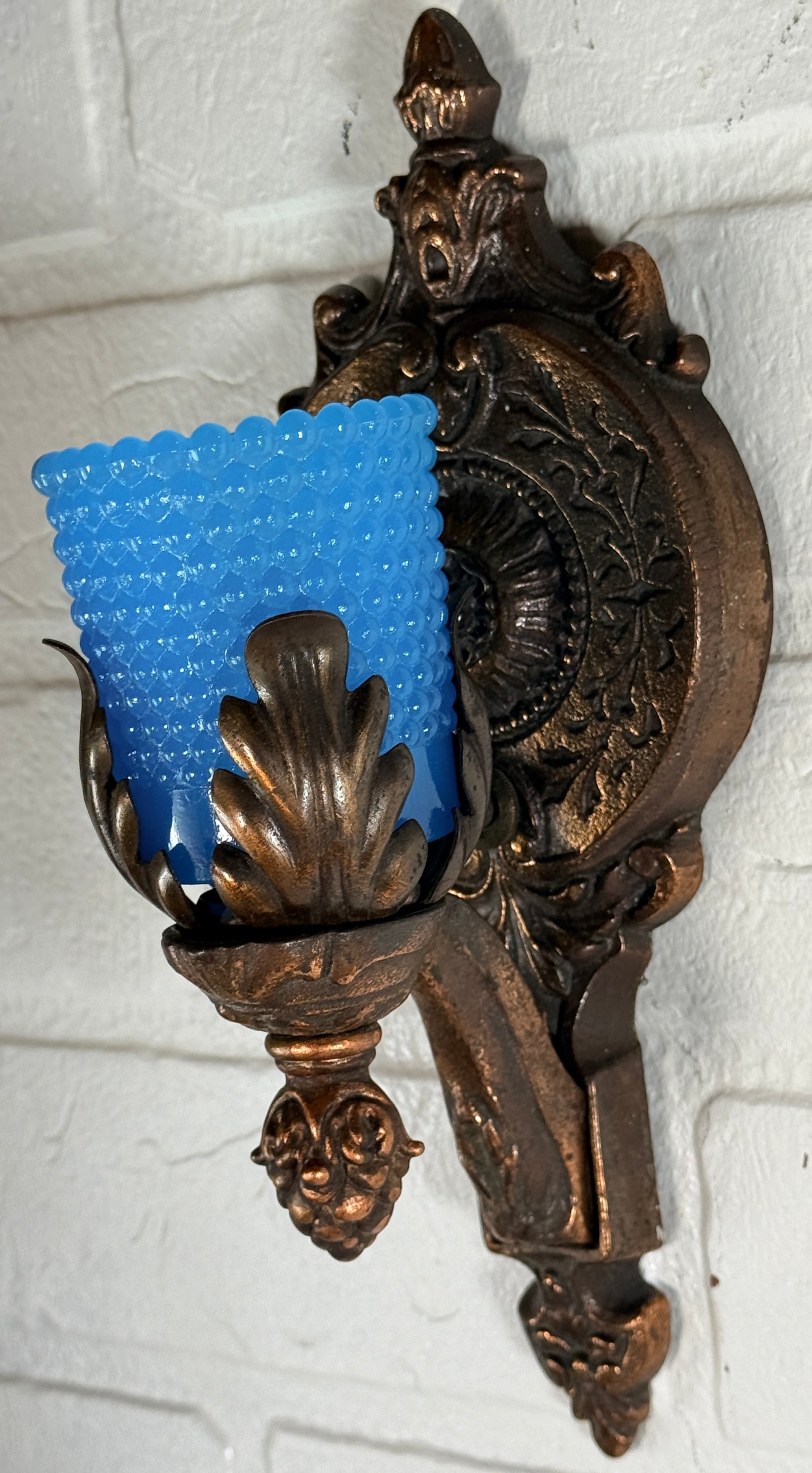 Vintage Hollywood Regency wall sconces pair with gold leaf finish and blue hobnail glass shades. Ornate cast metal accent lighting, 9.5 inch set of 2.