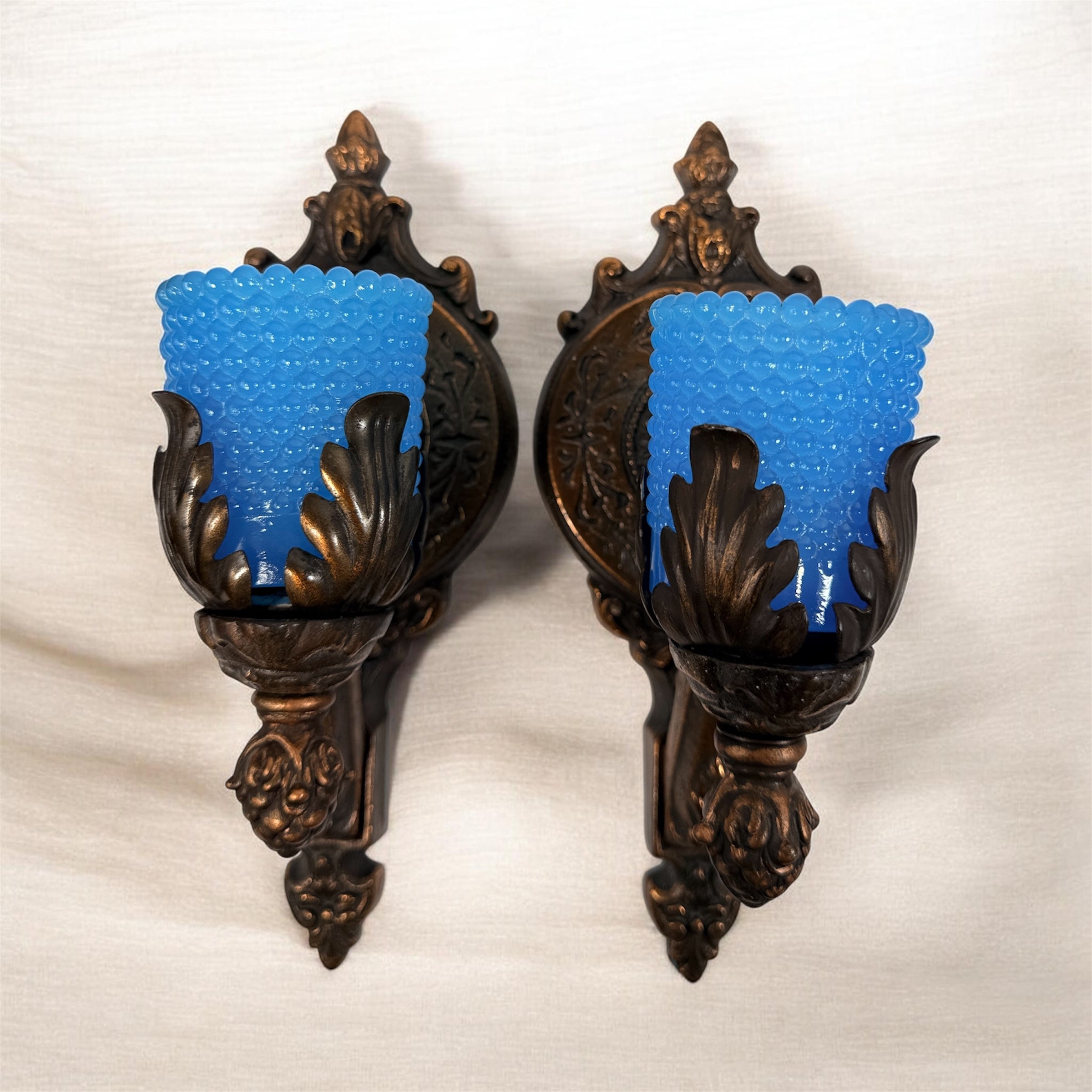 Vintage Hollywood Regency wall sconces pair with gold leaf finish and blue hobnail glass shades. Ornate cast metal accent lighting, 9.5 inch set of 2.