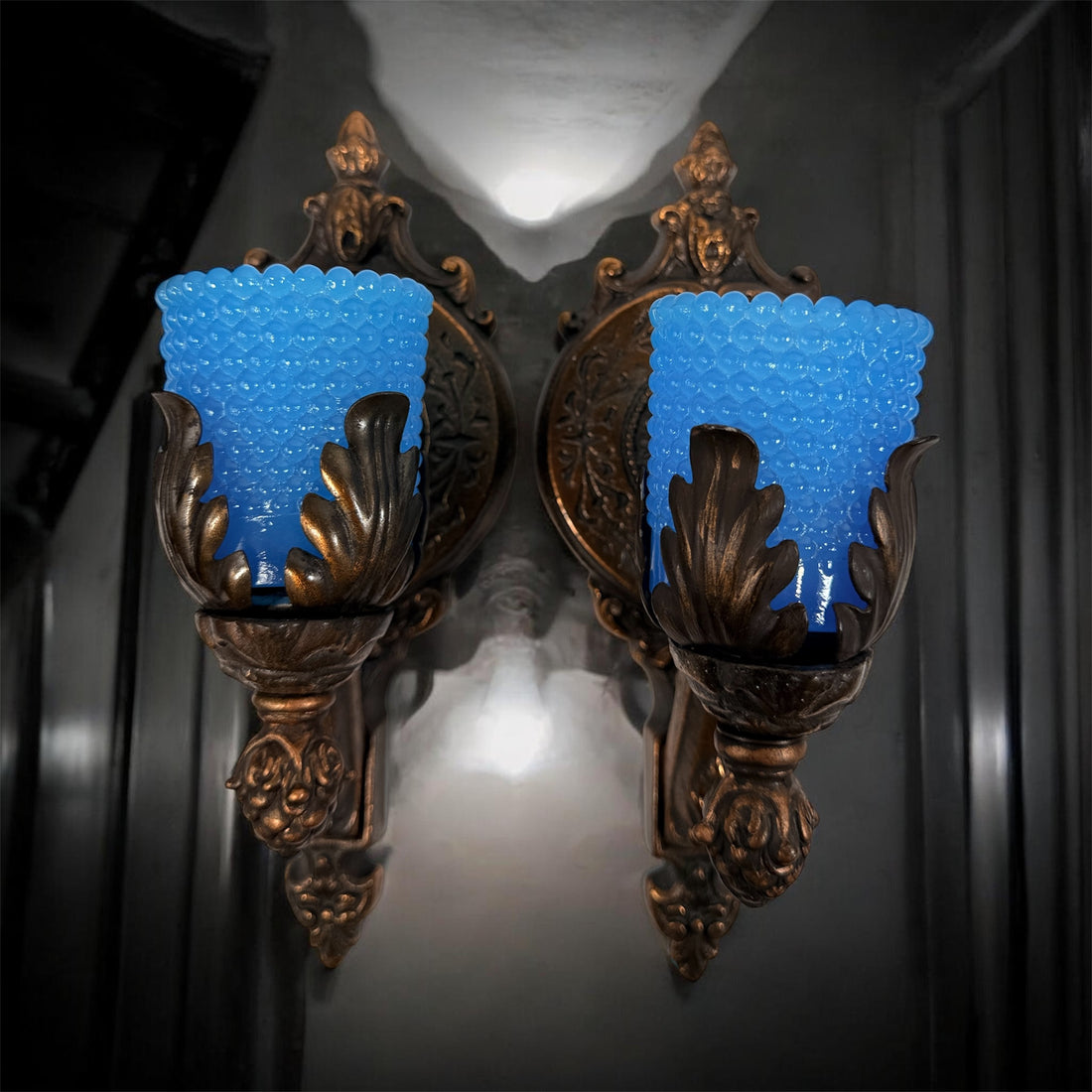 Vintage Hollywood Regency wall sconces pair with gold leaf finish and blue hobnail glass shades. Ornate cast metal accent lighting, 9.5 inch set of 2.