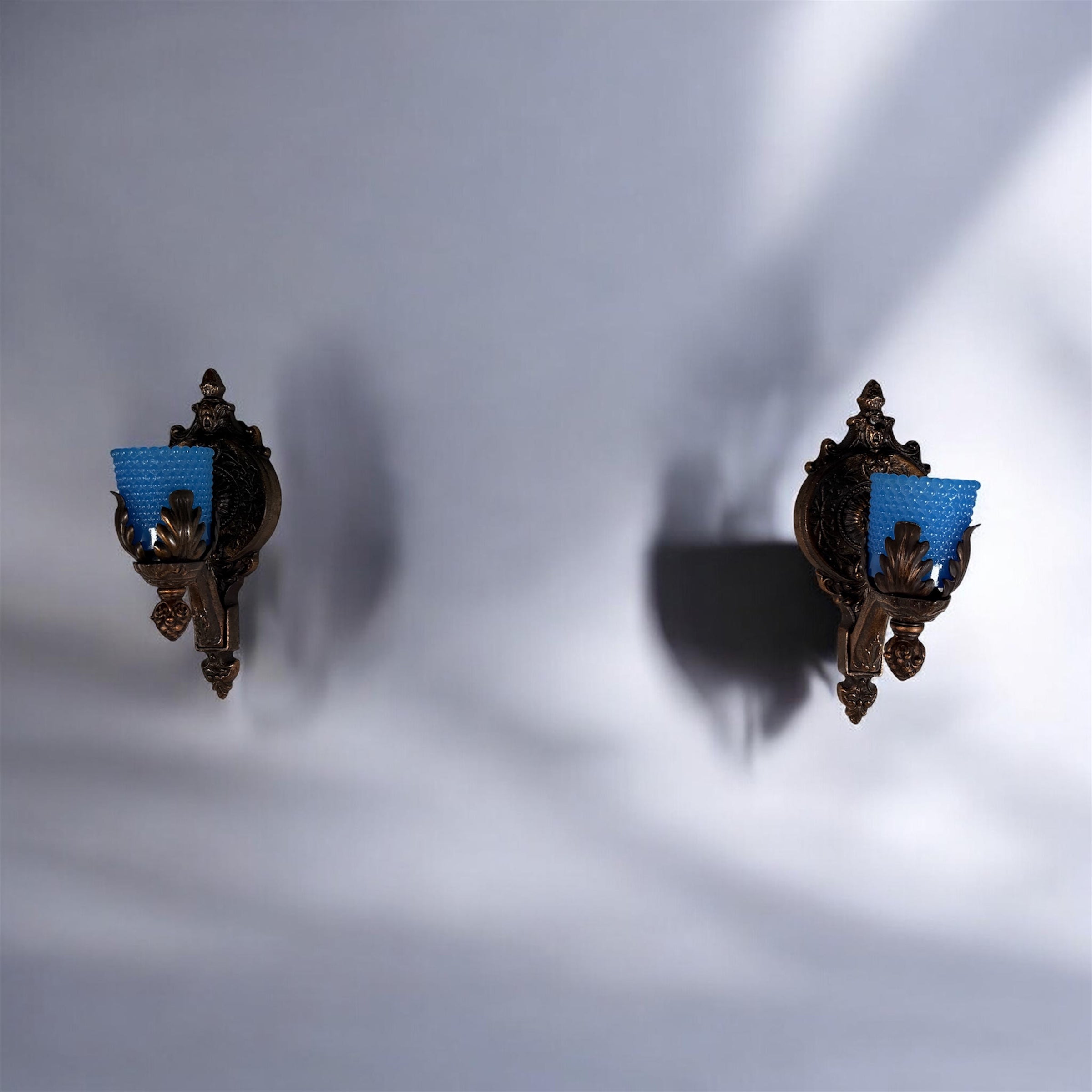 Vintage Hollywood Regency wall sconces pair with gold leaf finish and blue hobnail glass shades. Ornate cast metal accent lighting, 9.5 inch set of 2.