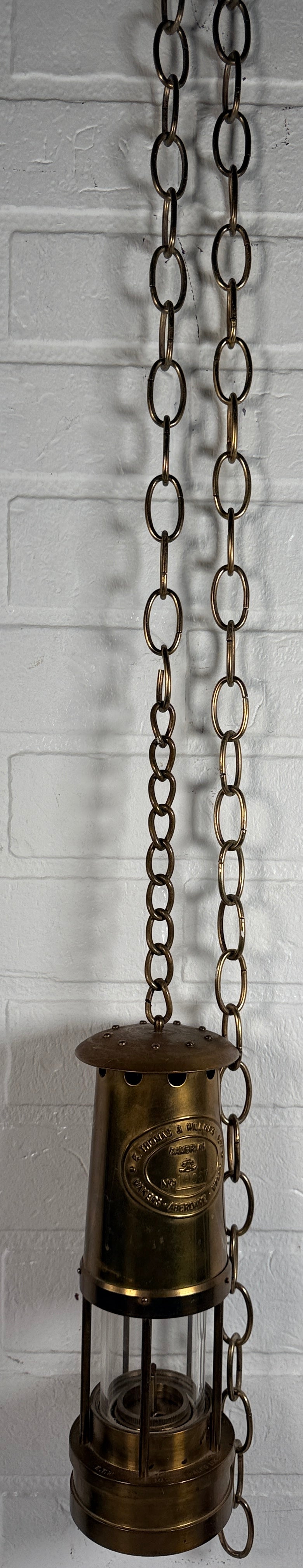 Authentic Thomas Williams Cambrian Welsh miners lamp in brass with chain. Classic industrial decor collectible marked Aberdare Wales.