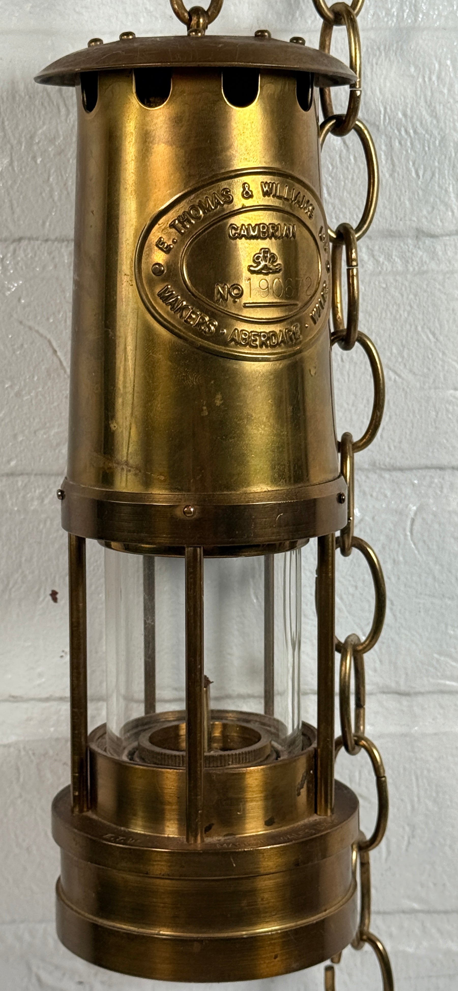 Authentic Thomas Williams Cambrian Welsh miners lamp in brass with chain. Classic industrial decor collectible marked Aberdare Wales.