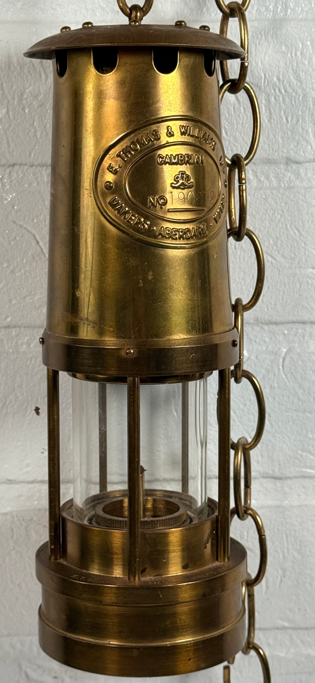Authentic Thomas Williams Cambrian Welsh miners lamp in brass with chain. Classic industrial decor collectible marked Aberdare Wales.