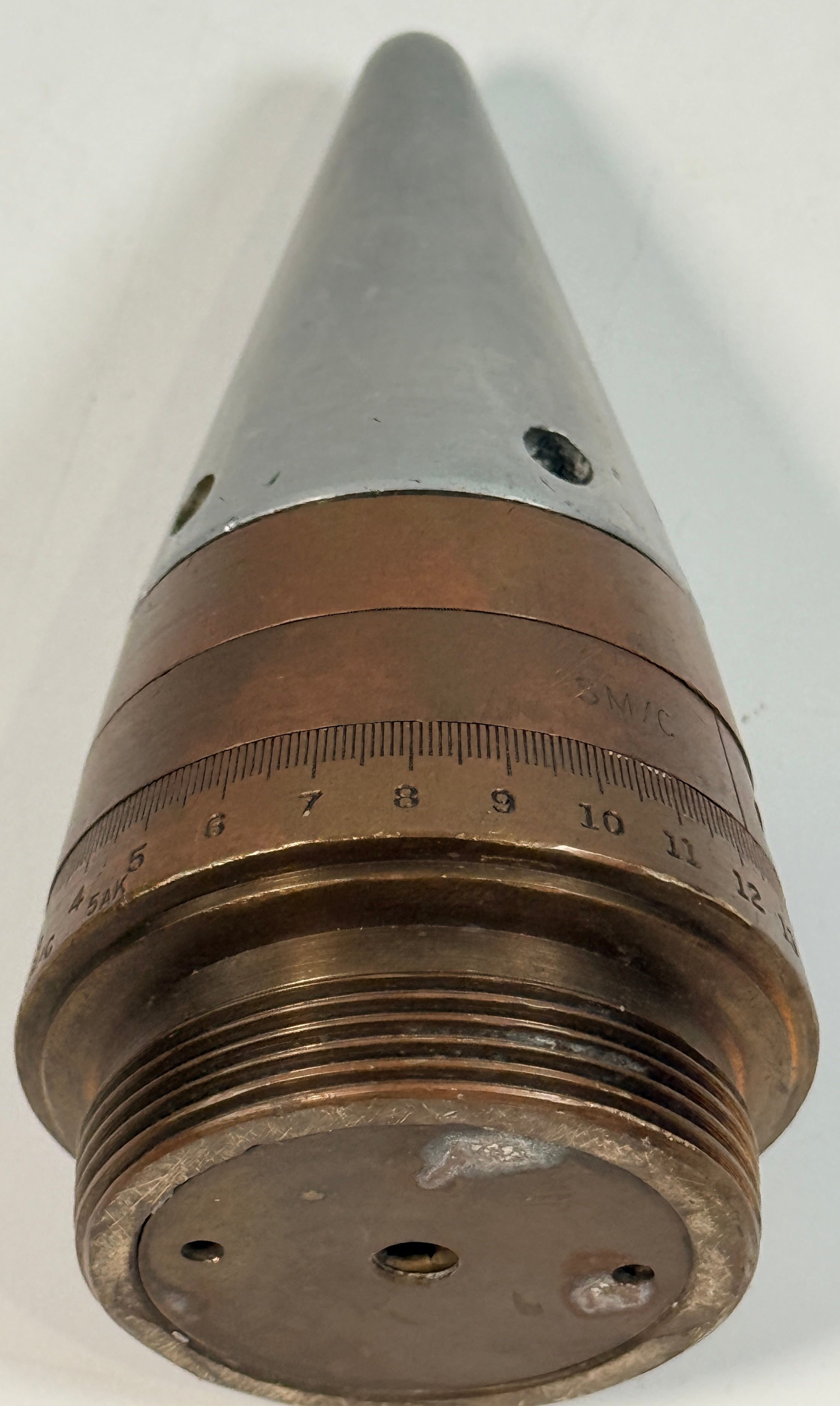 WWII British mechanical time fuze Mk IV brass and aluminum artillery nose assembly. Authentic militaria collectible with timer dial and industrial display appeal.