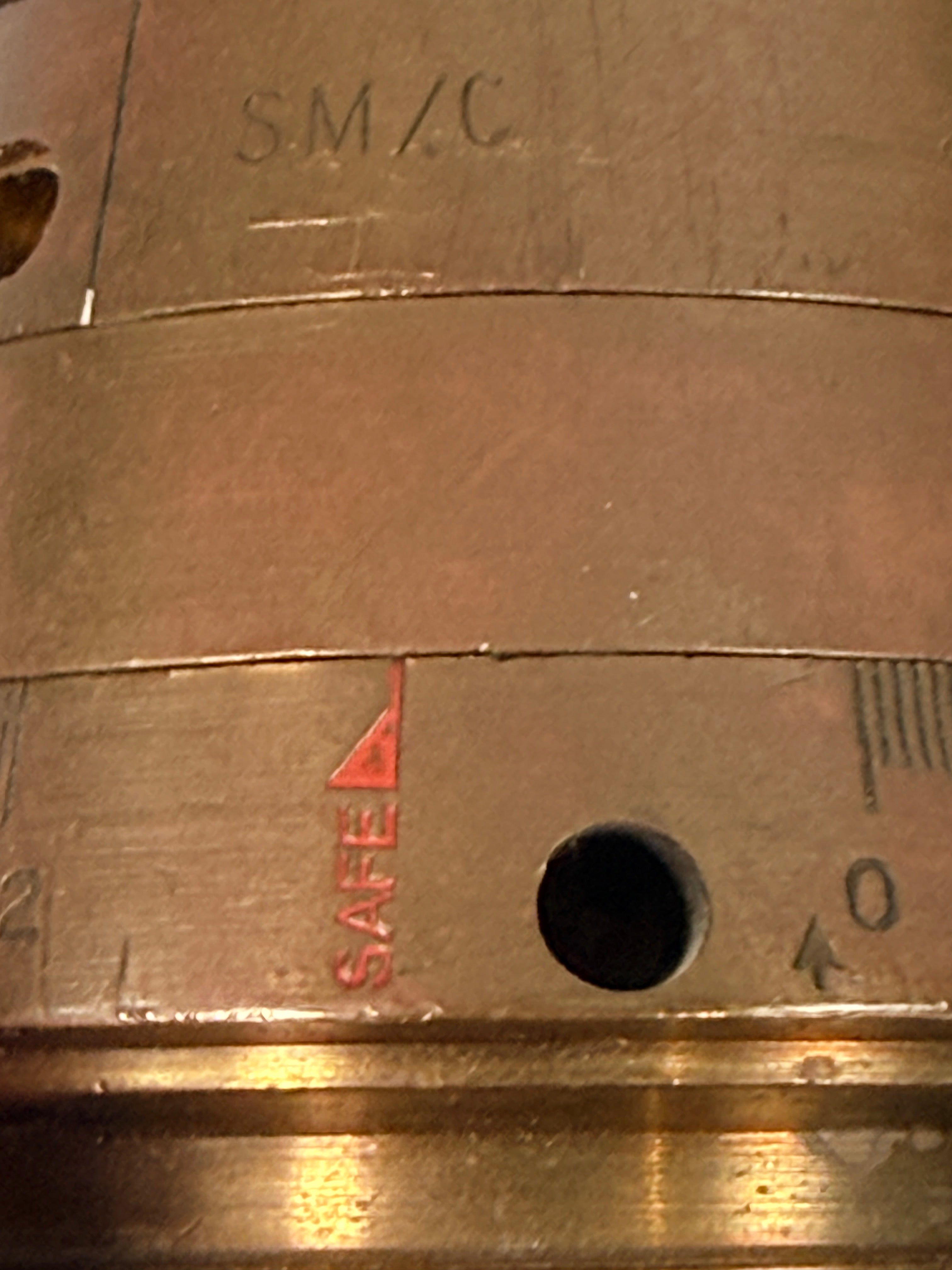 WWII British mechanical time fuze Mk IV brass and aluminum artillery nose assembly. Authentic militaria collectible with timer dial and industrial display appeal.