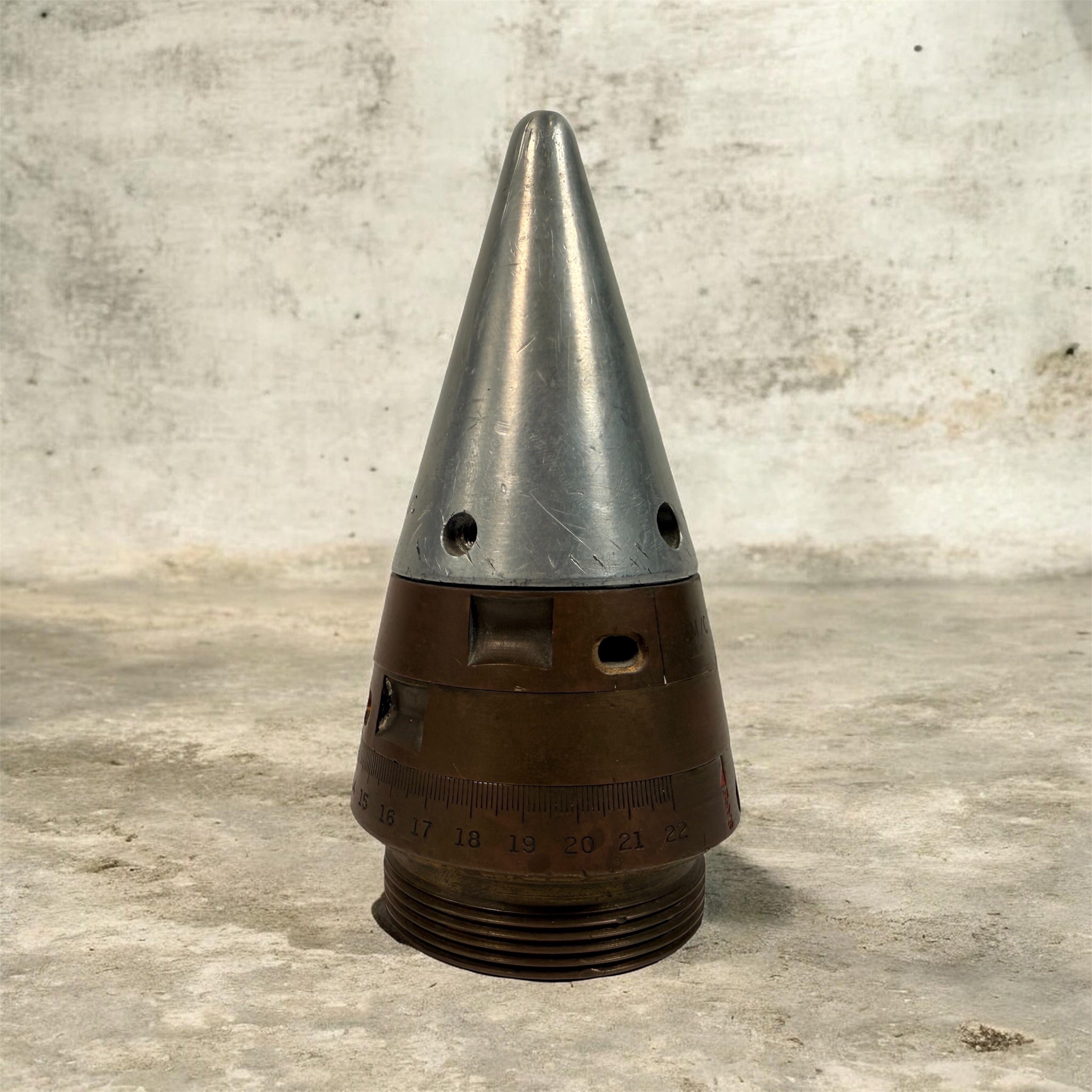 WWII British mechanical time fuze Mk IV brass and aluminum artillery nose assembly. Authentic militaria collectible with timer dial and industrial display appeal.