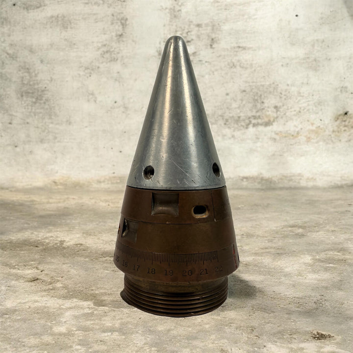 WWII British mechanical time fuze Mk IV brass and aluminum artillery nose assembly. Authentic militaria collectible with timer dial and industrial display appeal.