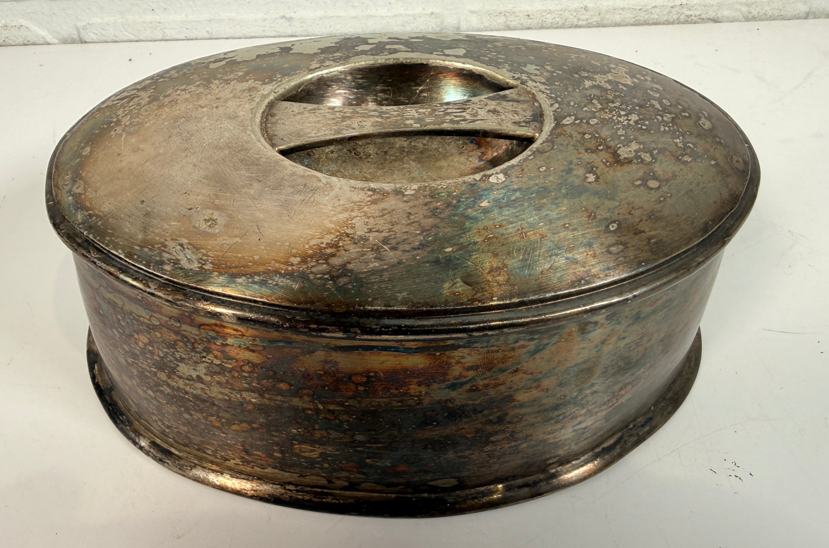Vintage silverplate silent butler crumb catcher with oval form and rich aged patina. Elegant mid-century dining accessory and collectible tableware piece.