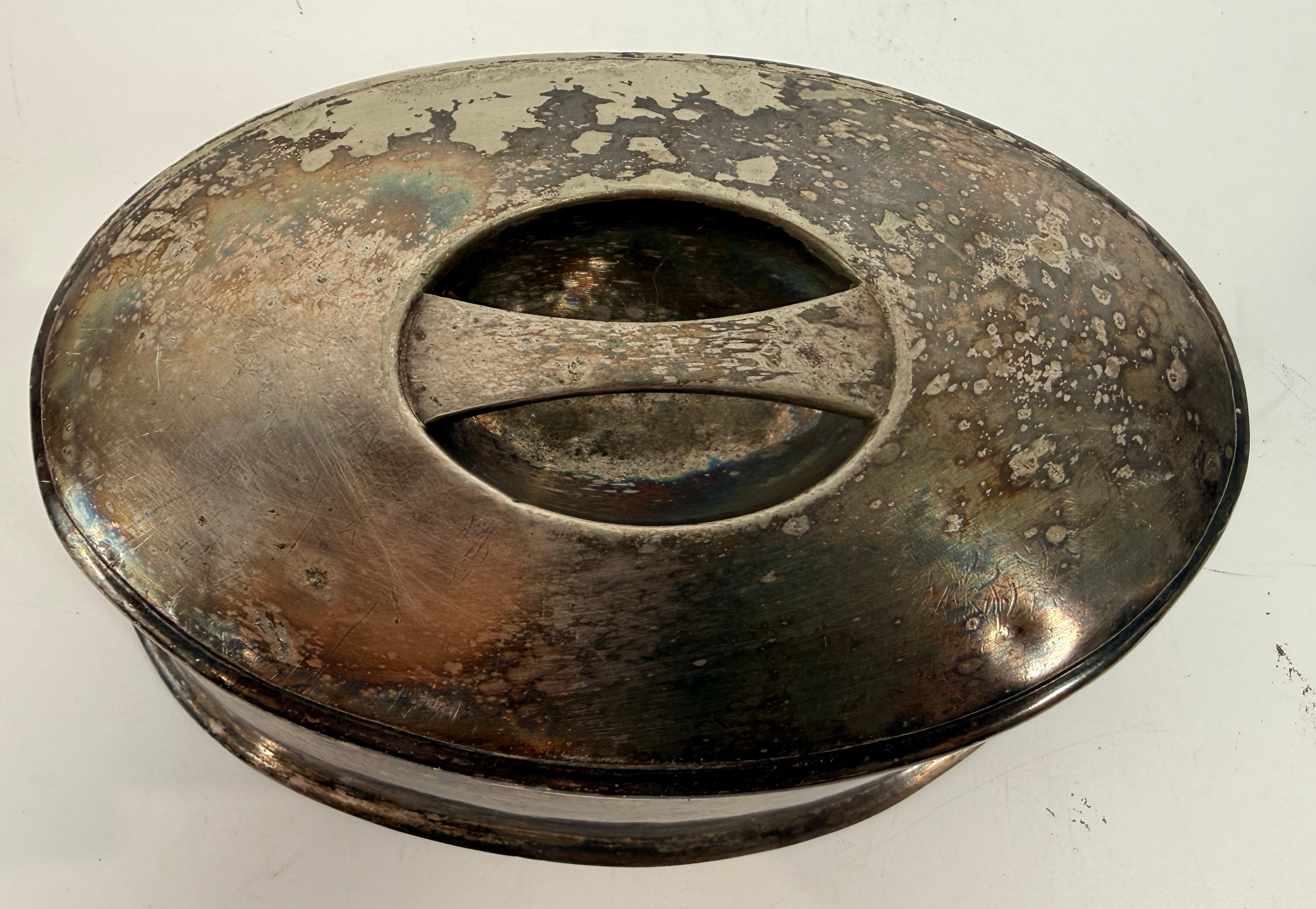 Vintage silverplate silent butler crumb catcher with oval form and rich aged patina. Elegant mid-century dining accessory and collectible tableware piece.