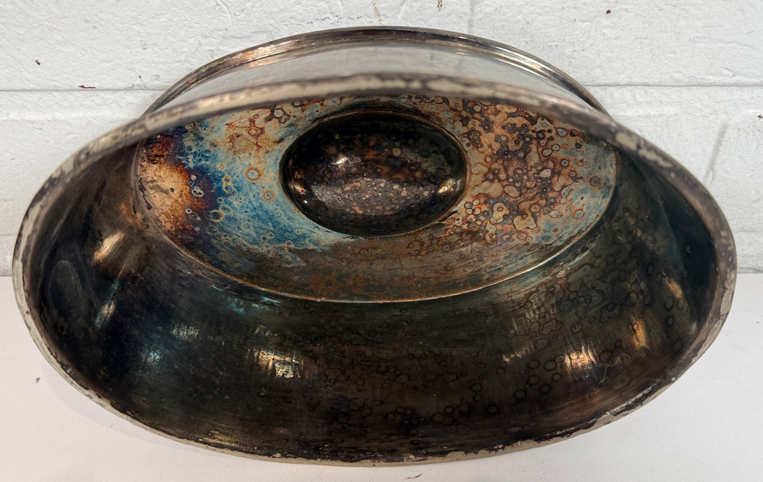 Vintage silverplate silent butler crumb catcher with oval form and rich aged patina. Elegant mid-century dining accessory and collectible tableware piece.