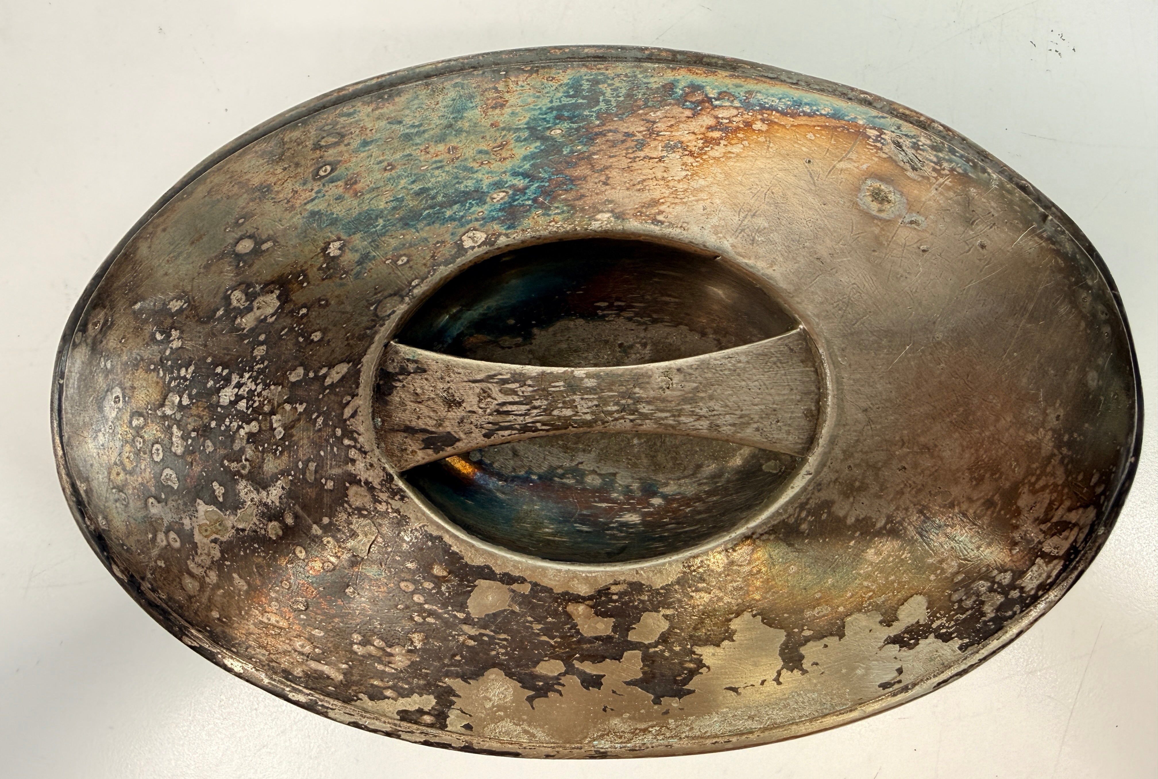 Vintage silverplate silent butler crumb catcher with oval form and rich aged patina. Elegant mid-century dining accessory and collectible tableware piece.