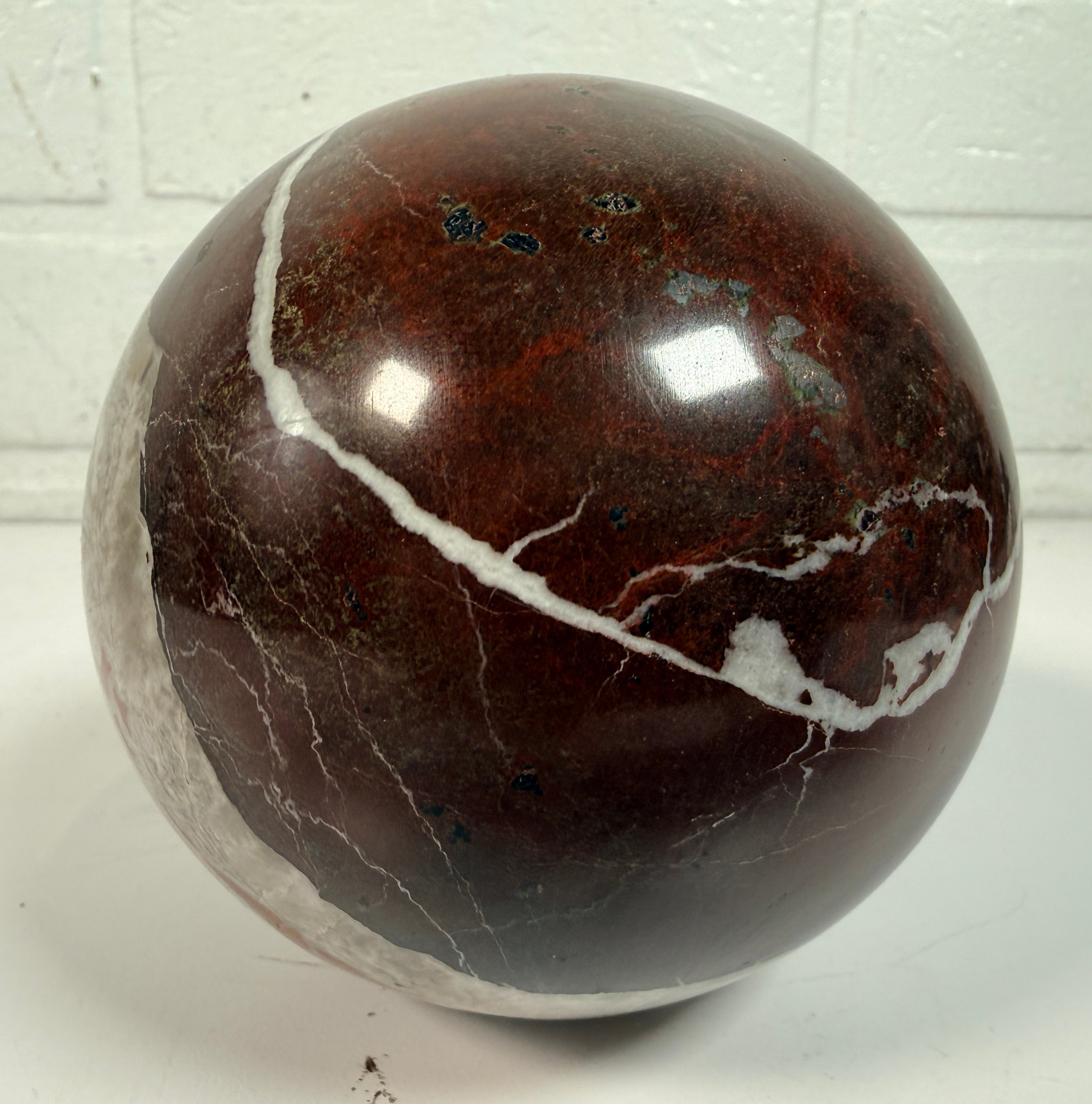 Large 4 inch Zebra Jasper sphere with rich red and white banding. Heavy polished natural stone orb, ideal for décor, gifting, or collectors.