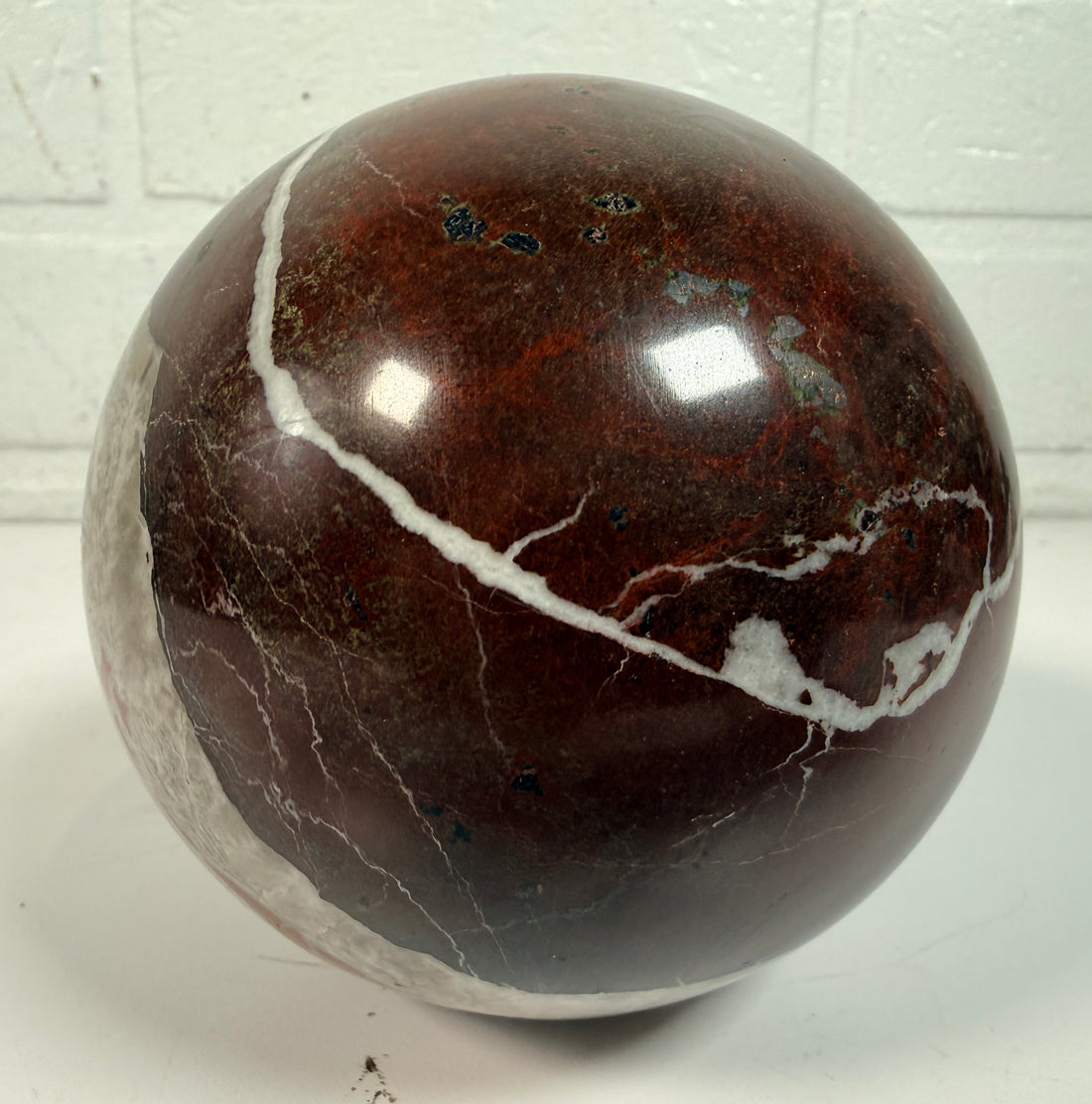 Large 4 inch Zebra Jasper sphere with rich red and white banding. Heavy polished natural stone orb, ideal for décor, gifting, or collectors.