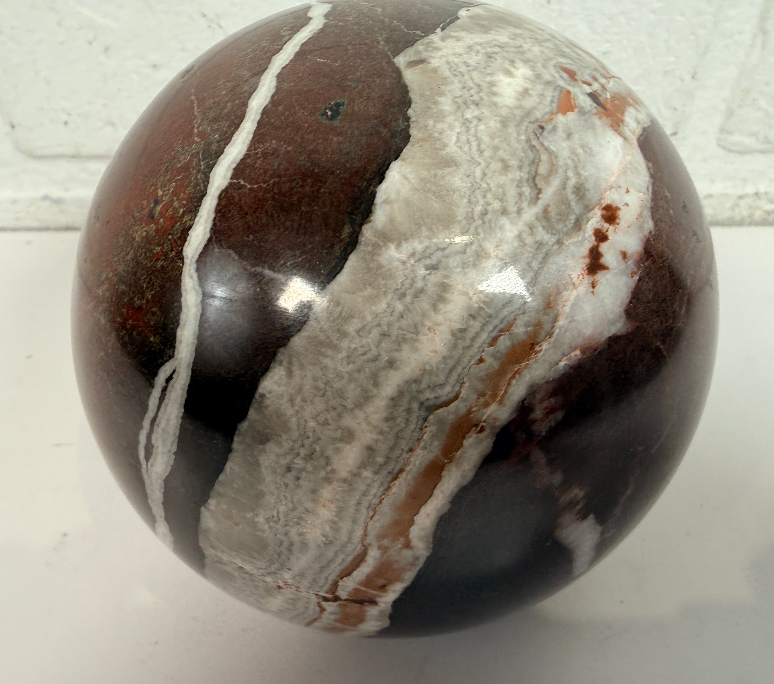 Large 4 inch Zebra Jasper sphere with rich red and white banding. Heavy polished natural stone orb, ideal for décor, gifting, or collectors.