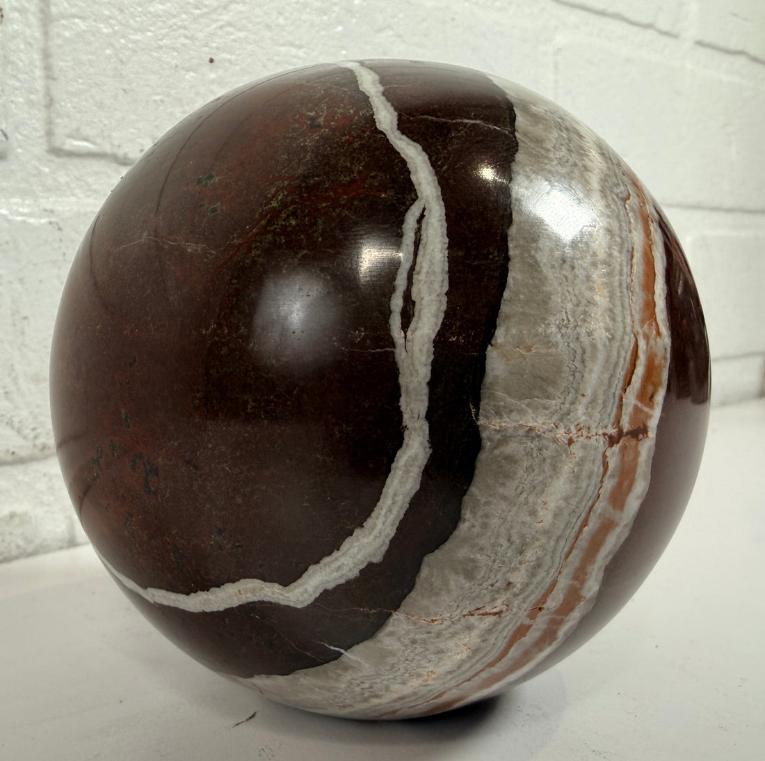 Large 4 inch Zebra Jasper sphere with rich red and white banding. Heavy polished natural stone orb, ideal for décor, gifting, or collectors.