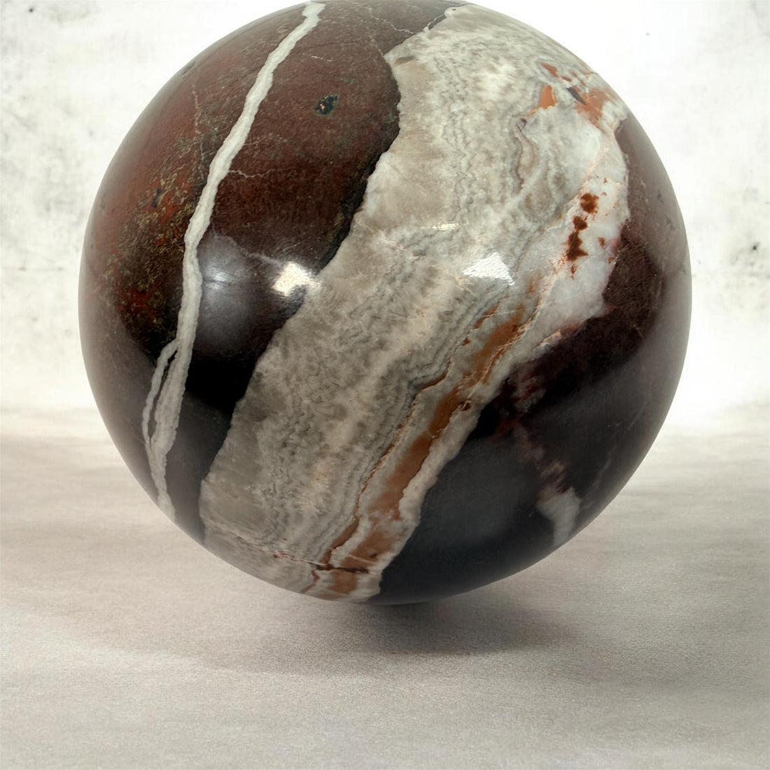 Large 4 inch Zebra Jasper sphere with rich red and white banding. Heavy polished natural stone orb, ideal for décor, gifting, or collectors.
