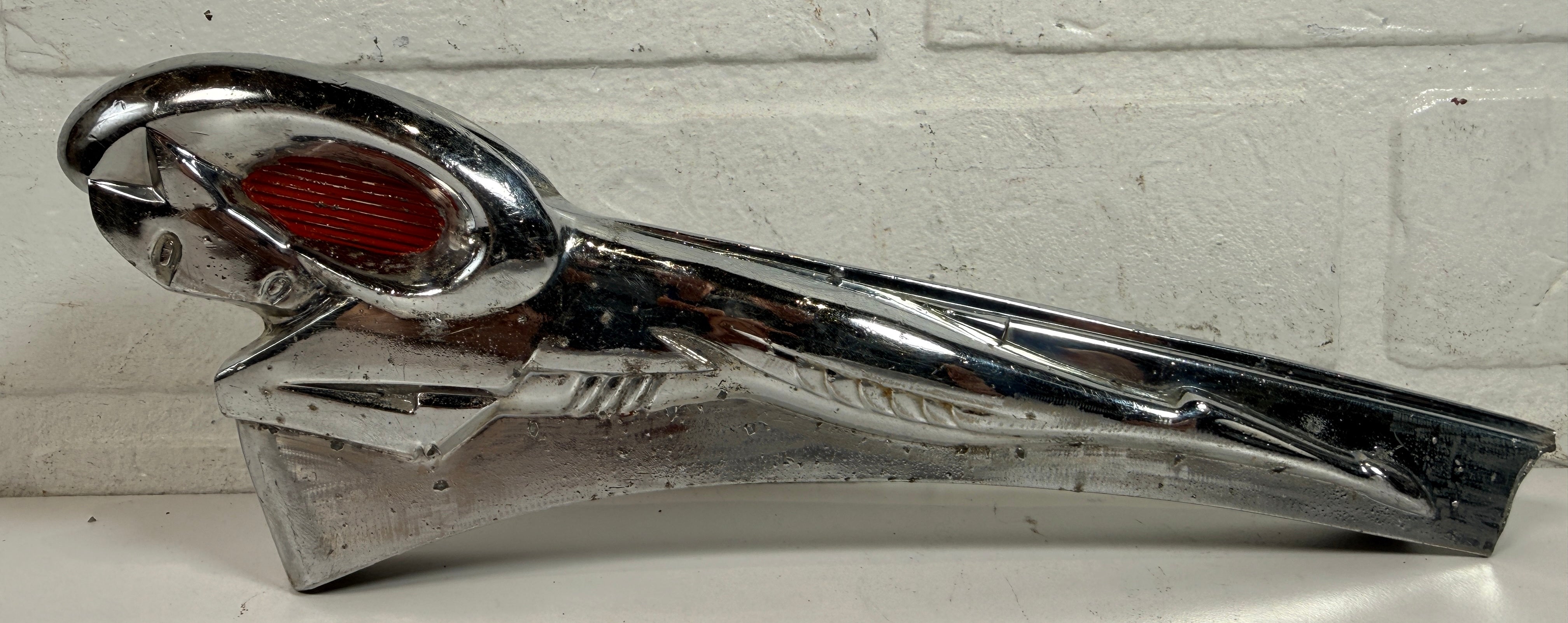 Vintage Dodge Ram hood ornament with red eyes, chrome mascot from the 1950s. Rare automobilia collectible for restoration, garage décor, or display
