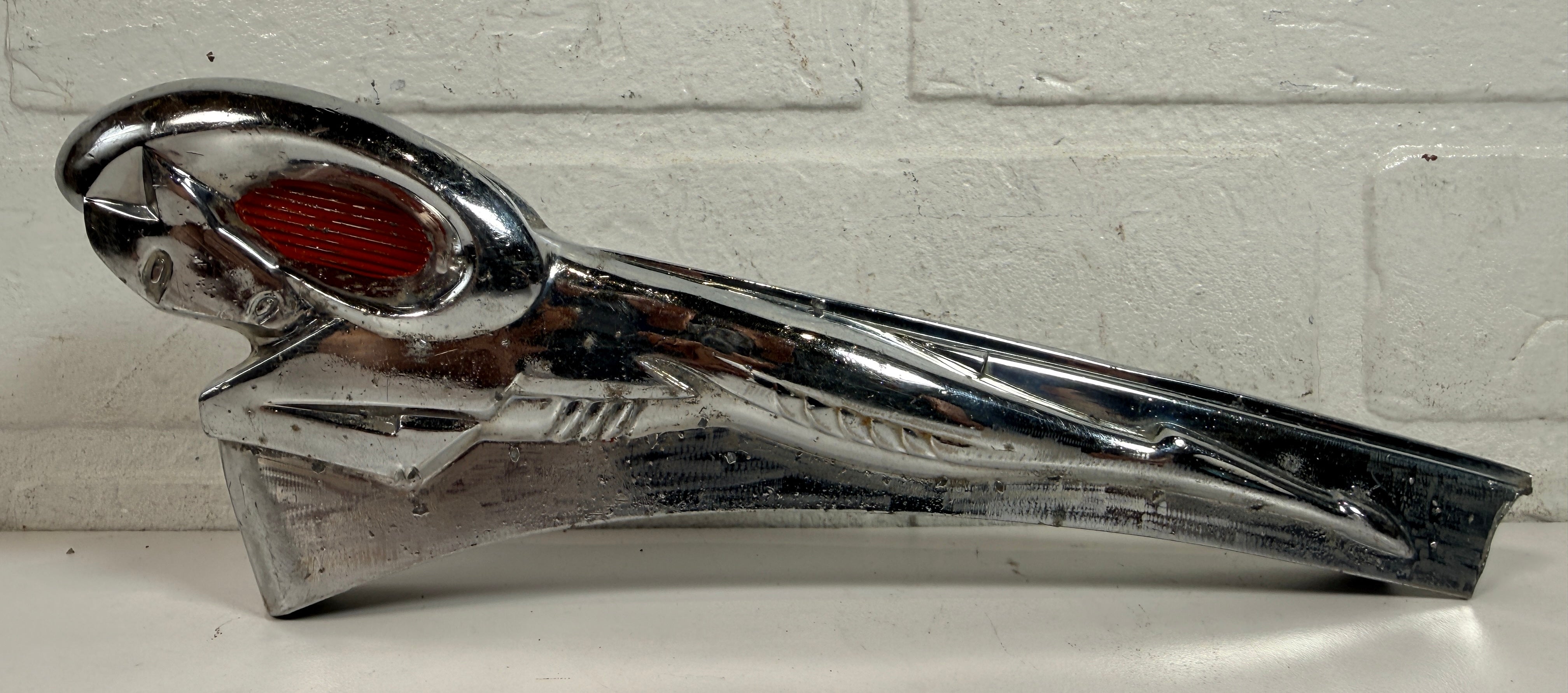 Vintage Dodge Ram hood ornament with red eyes, chrome mascot from the 1950s. Rare automobilia collectible for restoration, garage décor, or display