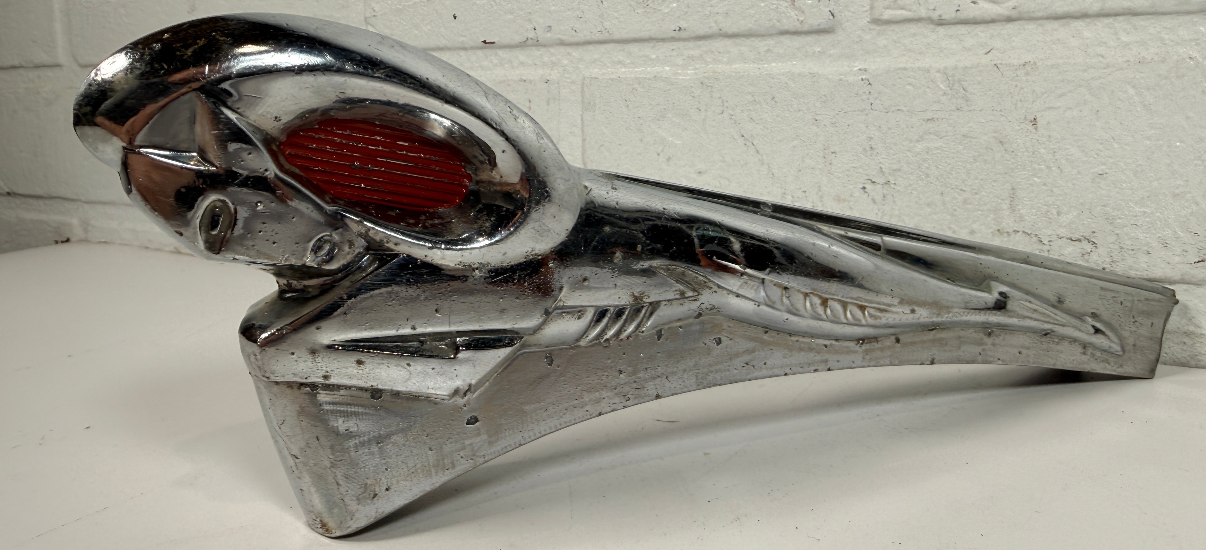 Vintage Dodge Ram hood ornament with red eyes, chrome mascot from the 1950s. Rare automobilia collectible for restoration, garage décor, or display