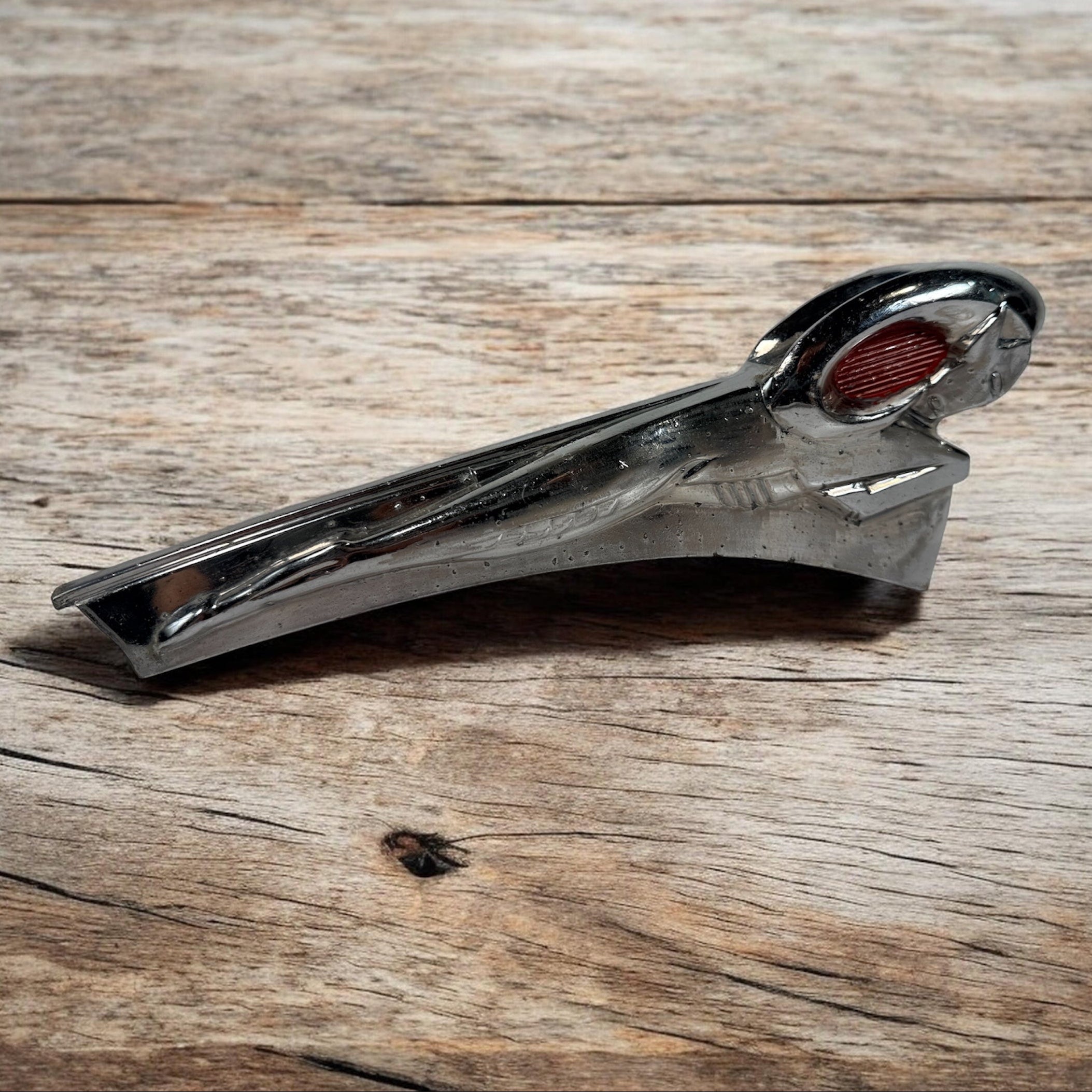 Vintage Dodge Ram hood ornament with red eyes, chrome mascot from the 1950s. Rare automobilia collectible for restoration, garage décor, or display
