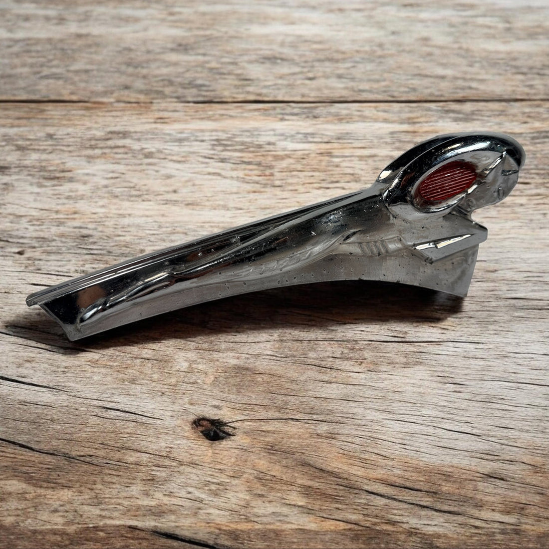 Vintage Dodge Ram hood ornament with red eyes, chrome mascot from the 1950s. Rare automobilia collectible for restoration, garage décor, or display