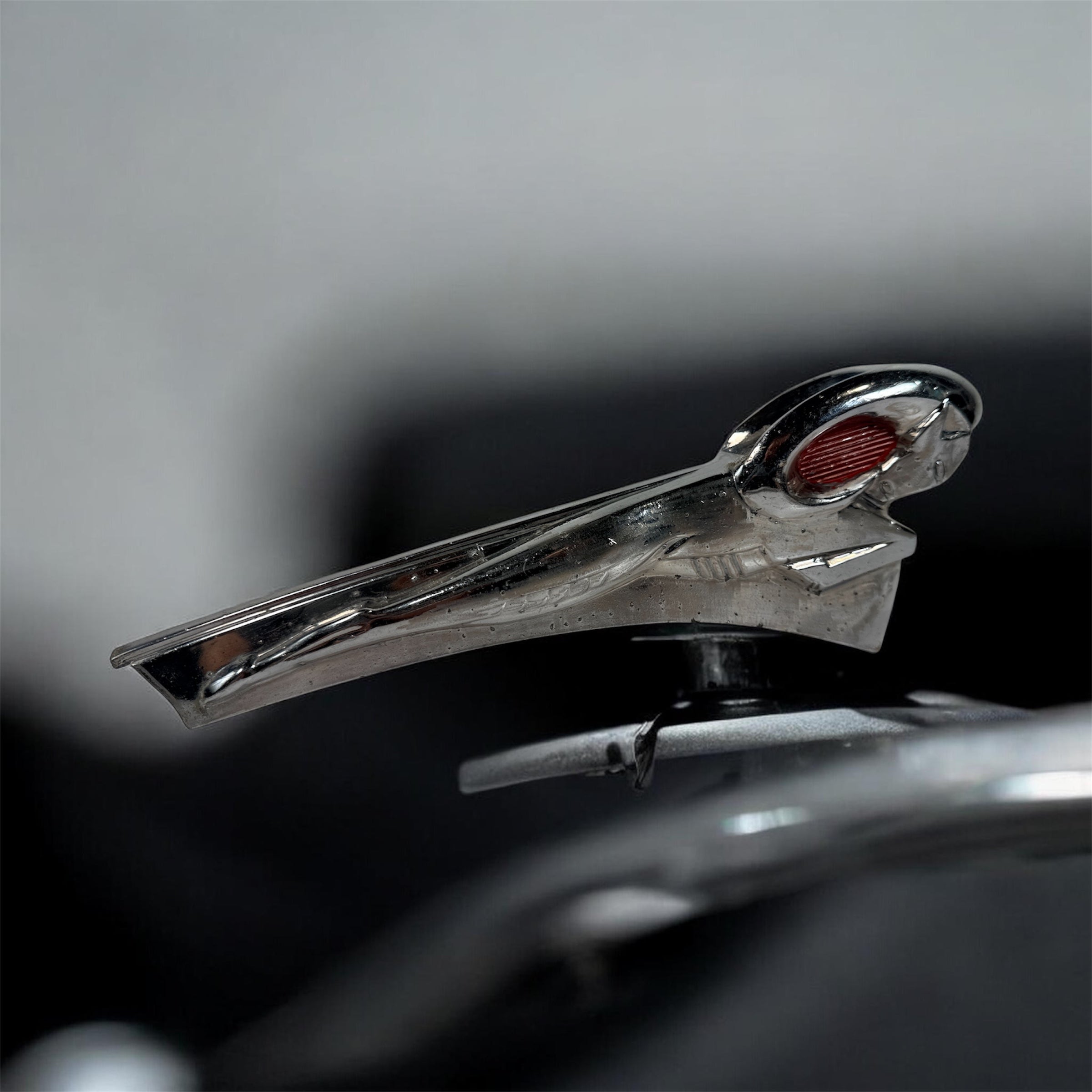 Vintage Dodge Ram hood ornament with red eyes, chrome mascot from the 1950s. Rare automobilia collectible for restoration, garage décor, or display