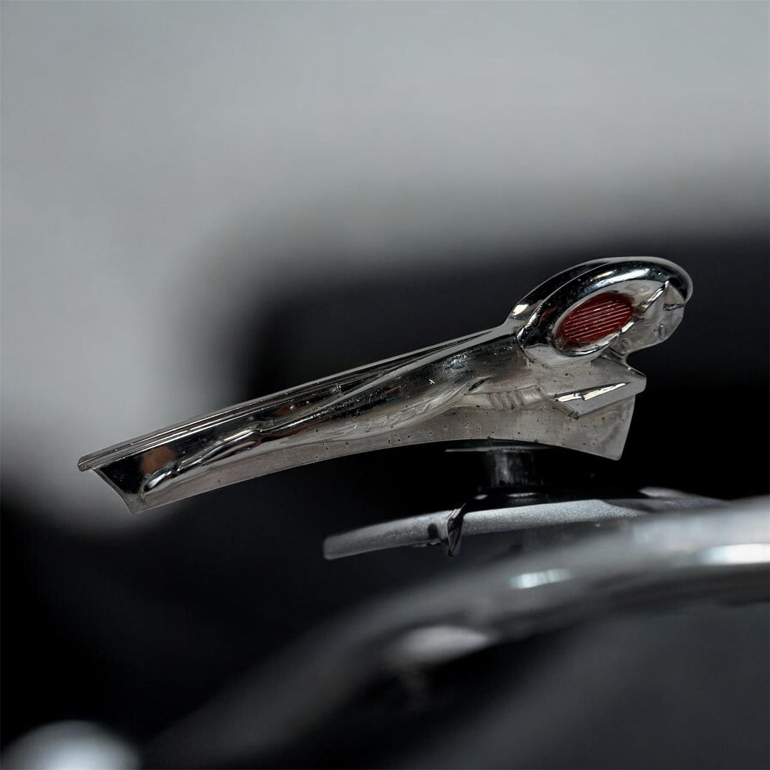 Vintage Dodge Ram hood ornament with red eyes, chrome mascot from the 1950s. Rare automobilia collectible for restoration, garage décor, or display