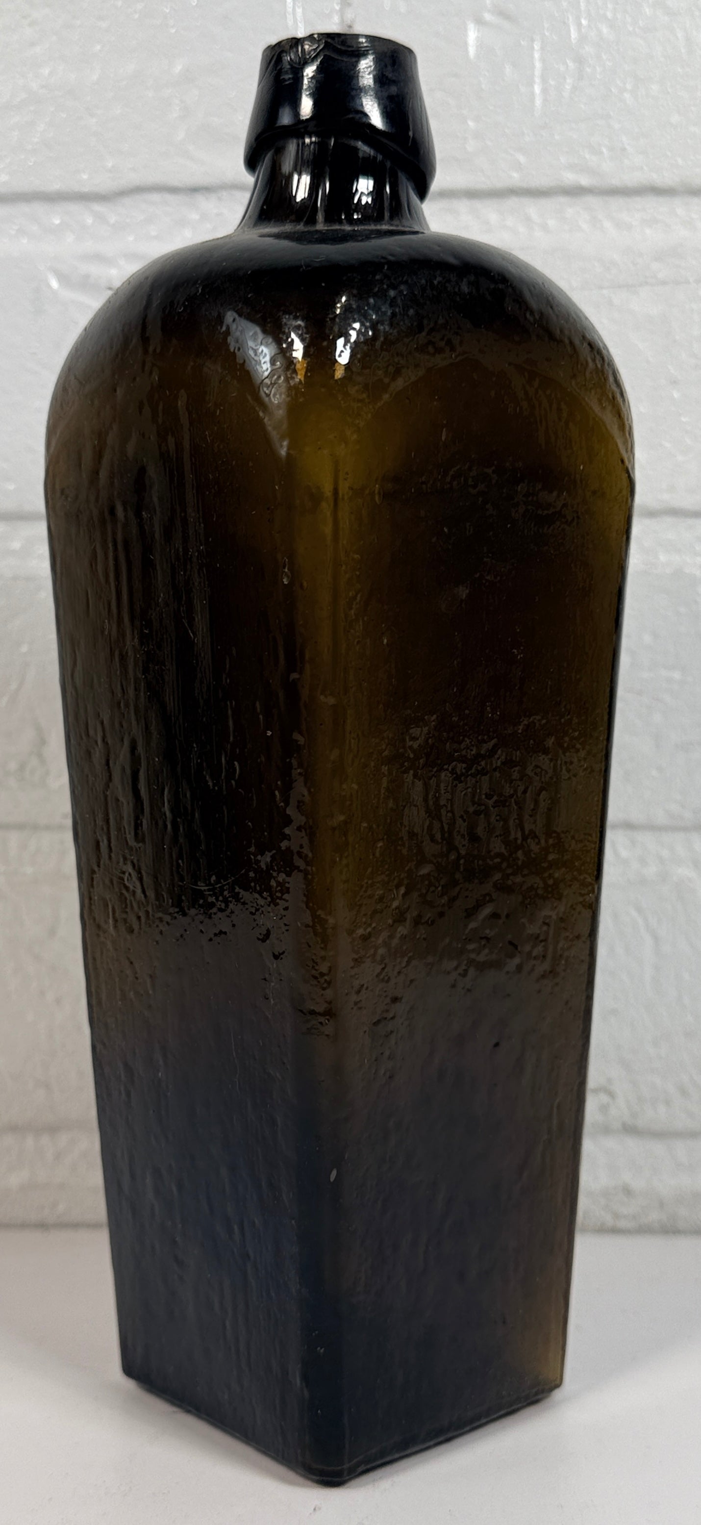 Bouteille de gin de collection en verre olive, style genièvre hollandais, carrée et effilée.