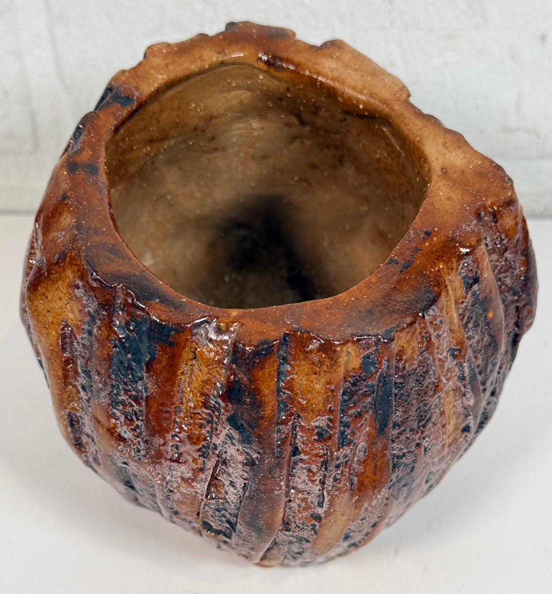 Vintage brutalist studio pottery planter with brown drip glaze and signed base. Mid-century handmade ceramic vessel for modern organic décor.