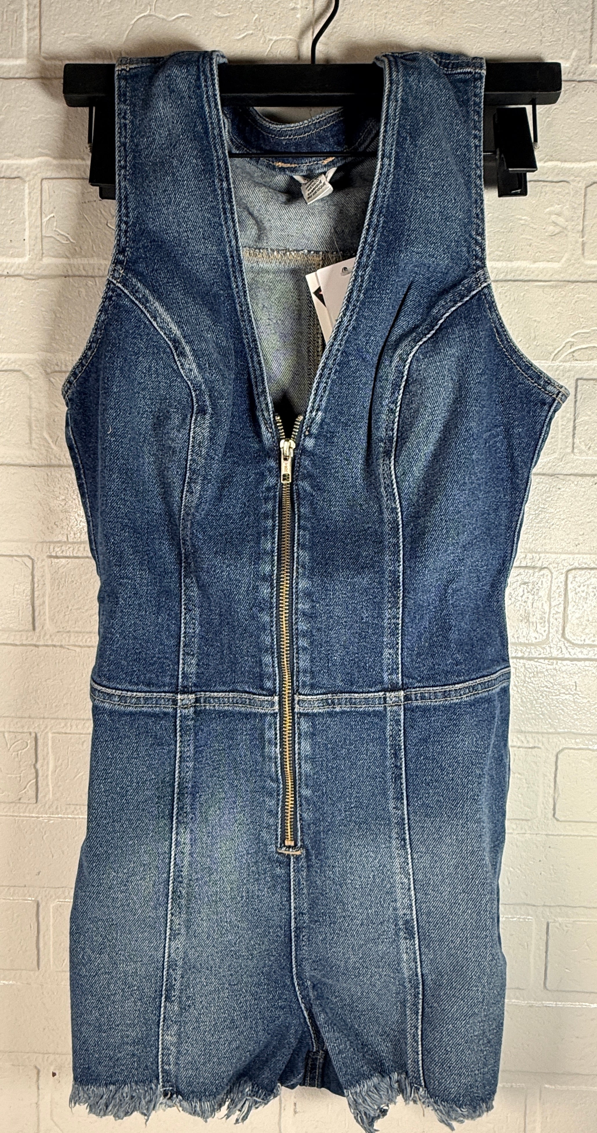 Guess Jennifer Lopez denim romper new with tags. Raw edge dark wash zip front shorts jumpsuit in medium size. Trendy Y2K style fashion piece.