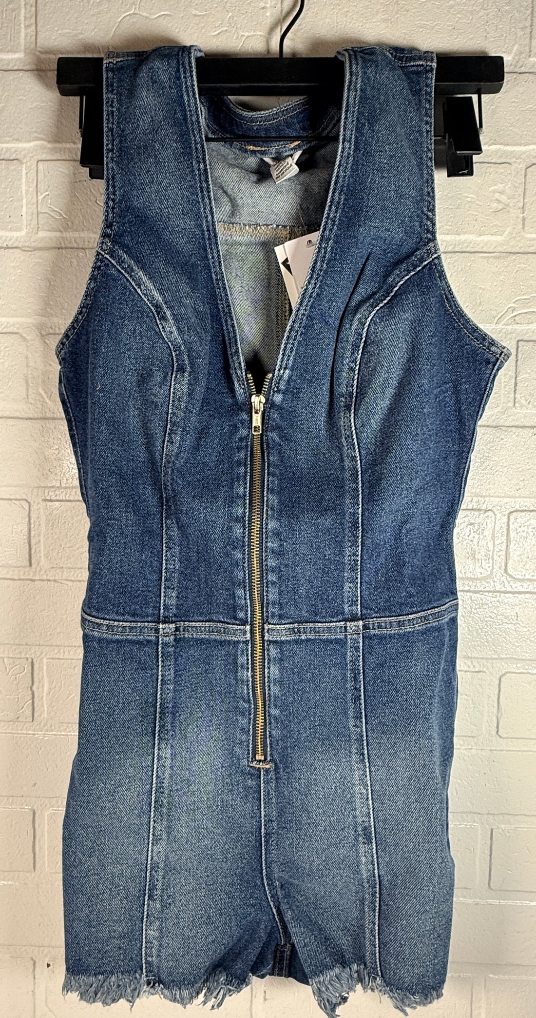 Guess Jennifer Lopez denim romper new with tags. Raw edge dark wash zip front shorts jumpsuit in medium size. Trendy Y2K style fashion piece.