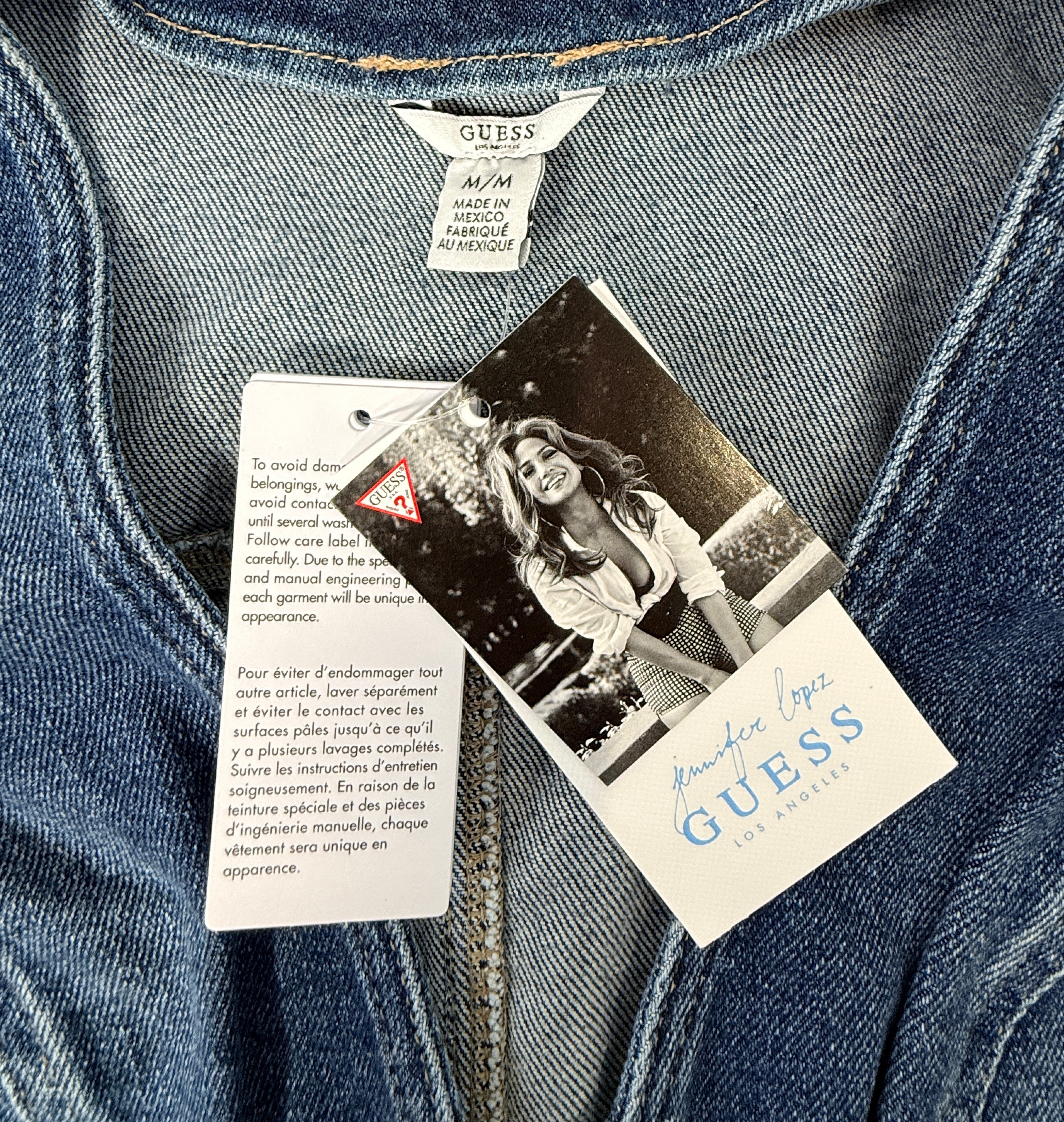 Guess Jennifer Lopez denim romper new with tags. Raw edge dark wash zip front shorts jumpsuit in medium size. Trendy Y2K style fashion piece.