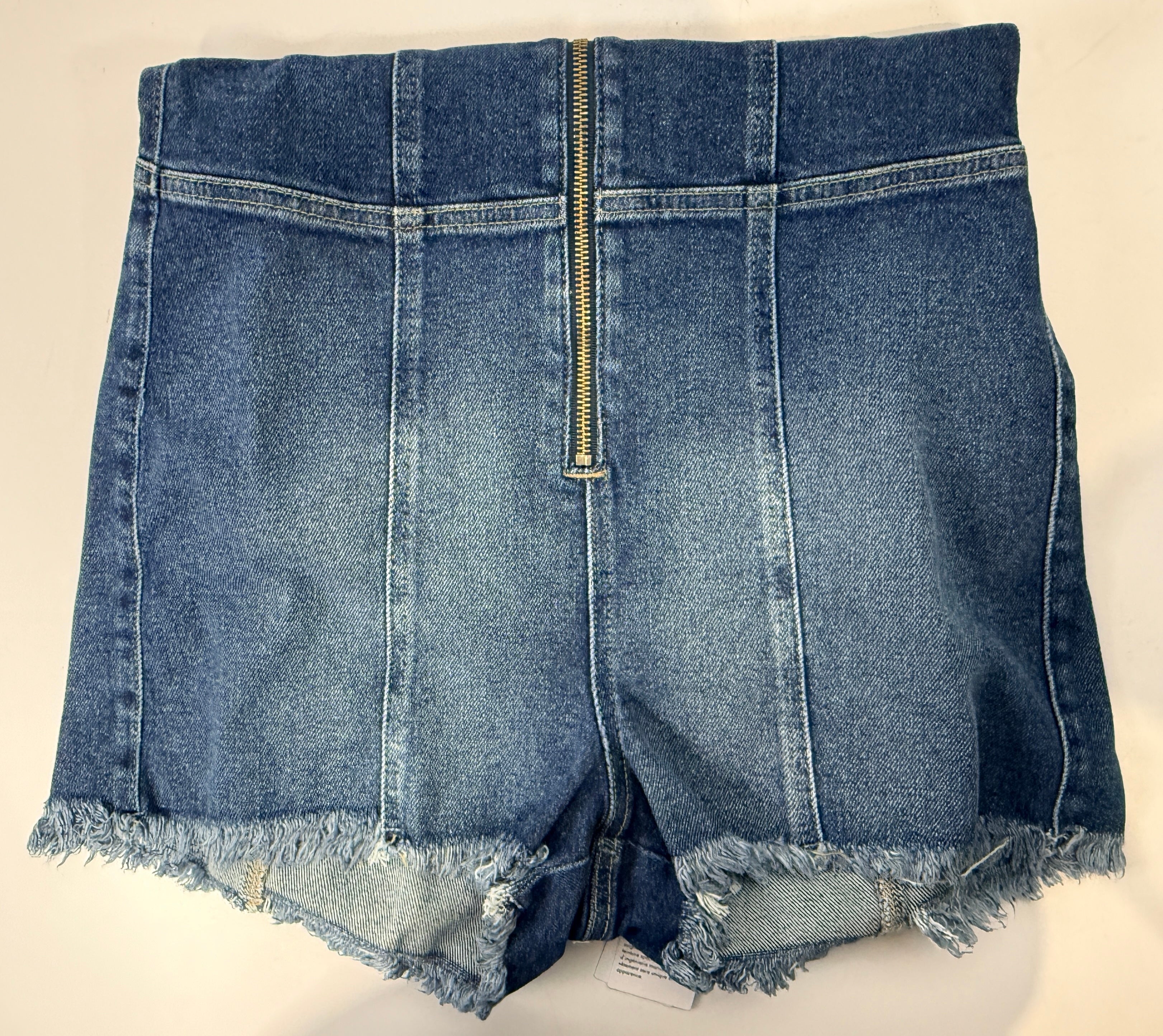 Guess Jennifer Lopez denim romper new with tags. Raw edge dark wash zip front shorts jumpsuit in medium size. Trendy Y2K style fashion piece.