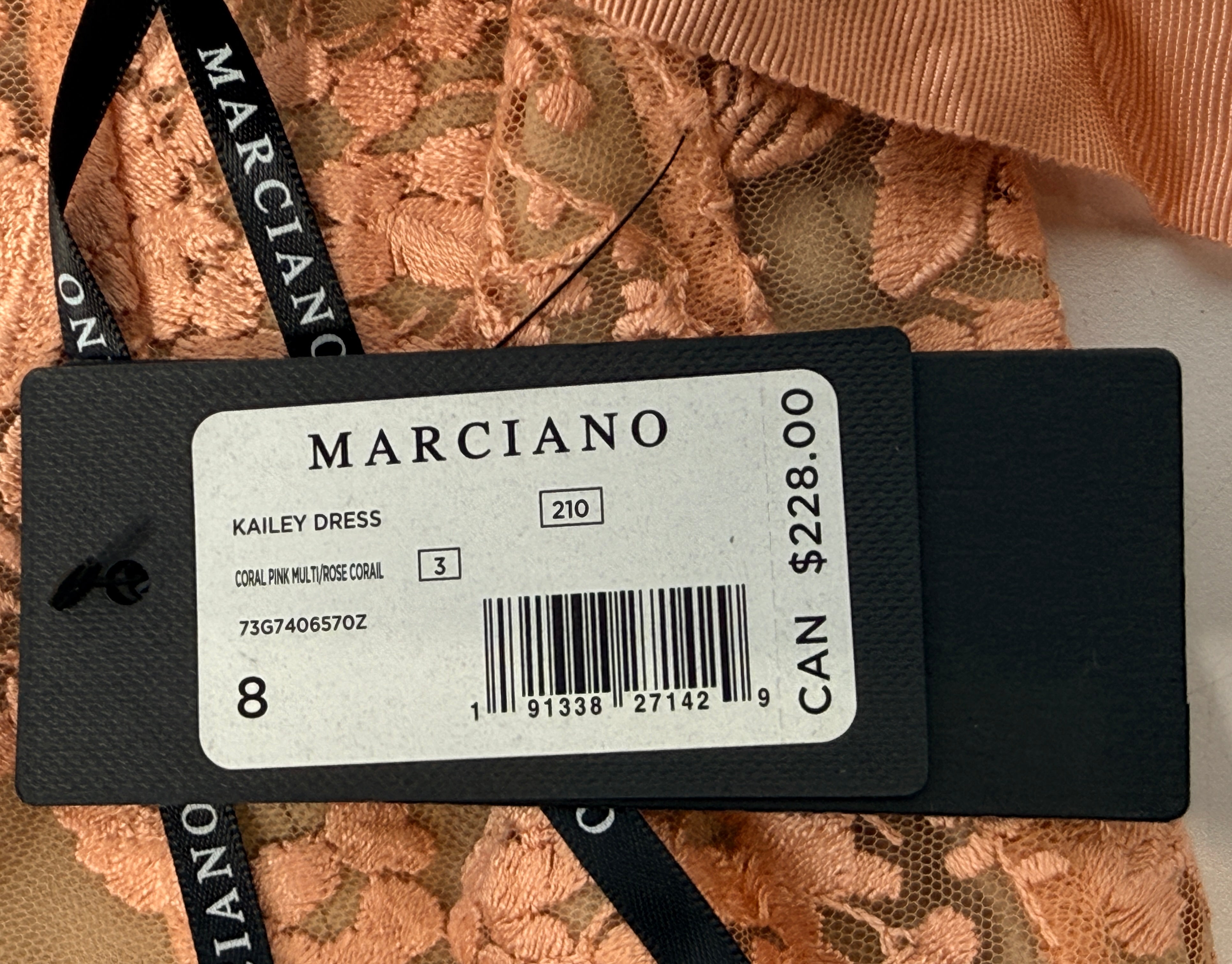 Marciano Kailey Dress size 8 in coral pink embroidered lace. Elegant formal gown with tags, fitted silhouette and sheer floral overlay.