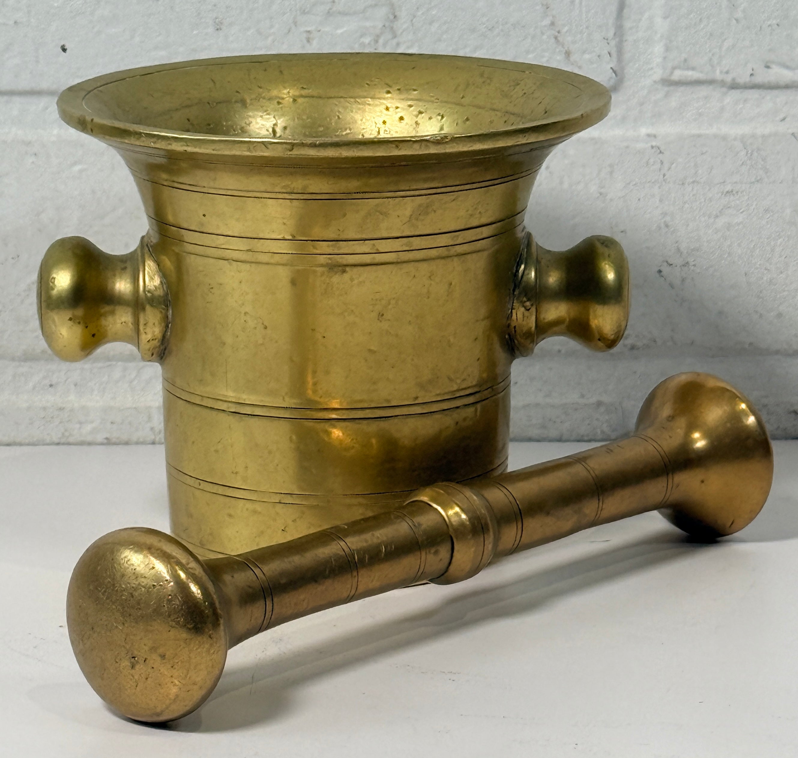 Vintage brass apothecary mortar and pestle, heavy cast with flared rim and rich patina. Classic pharmacy décor piece, functional and collectible.
