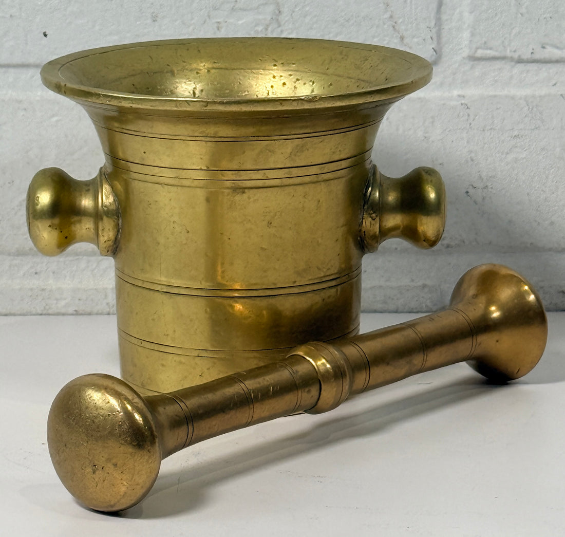 Vintage brass apothecary mortar and pestle, heavy cast with flared rim and rich patina. Classic pharmacy décor piece, functional and collectible.