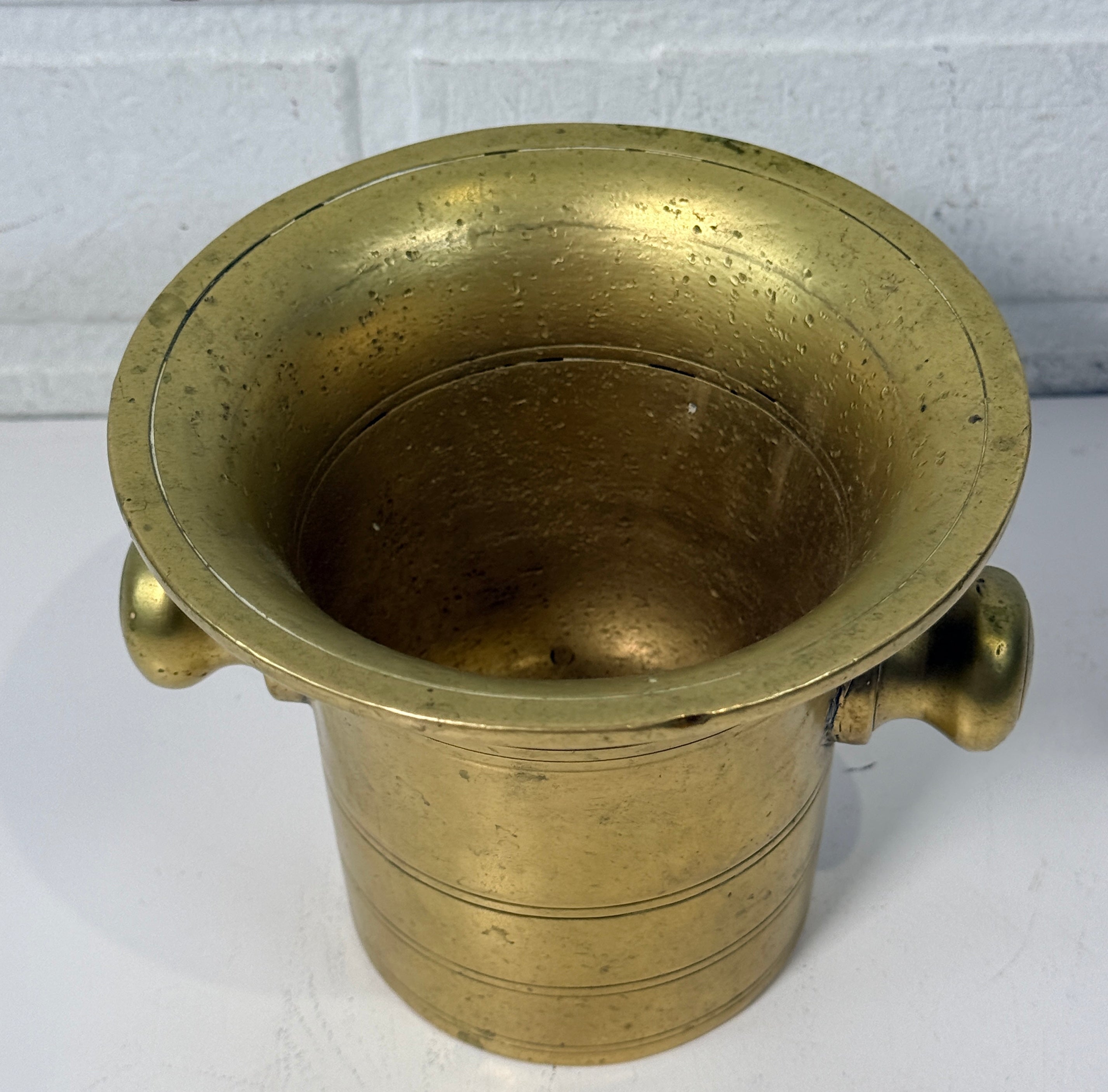 Vintage brass apothecary mortar and pestle, heavy cast with flared rim and rich patina. Classic pharmacy décor piece, functional and collectible.