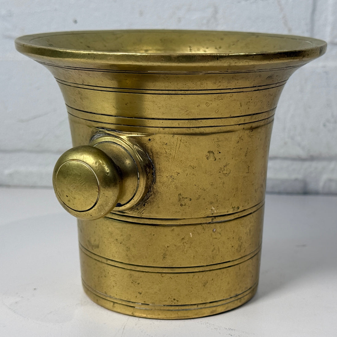 Vintage brass apothecary mortar and pestle, heavy cast with flared rim and rich patina. Classic pharmacy décor piece, functional and collectible.