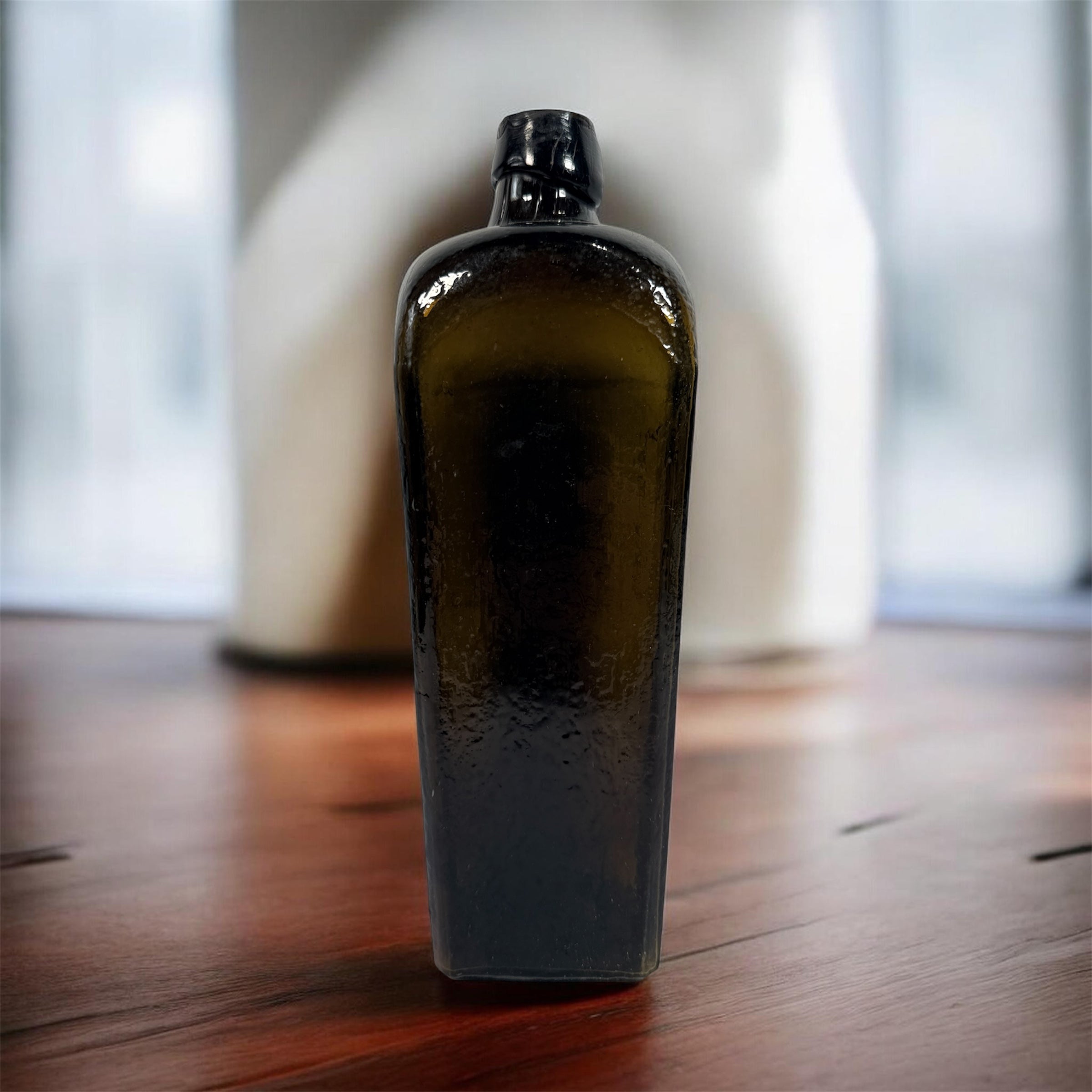 Collectible olive glass Case Gin bottle in classic Dutch jenever style. Square tapered vintage bottle perfect for bar decor, bottle collectors, and display.
