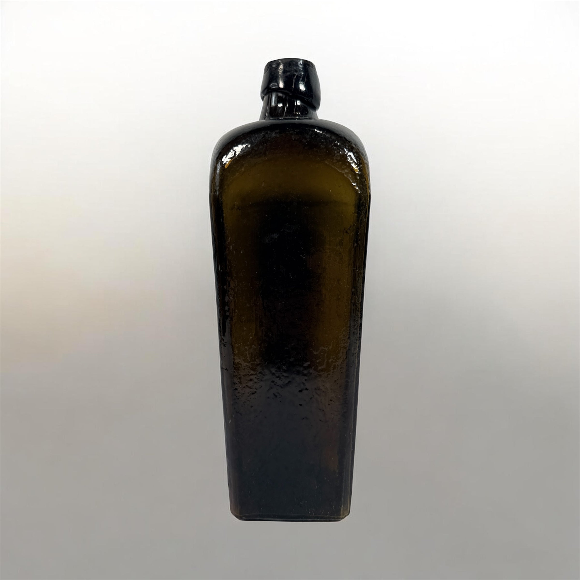 Collectible olive glass Case Gin bottle in classic Dutch jenever style. Square tapered vintage bottle perfect for bar decor, bottle collectors, and display.