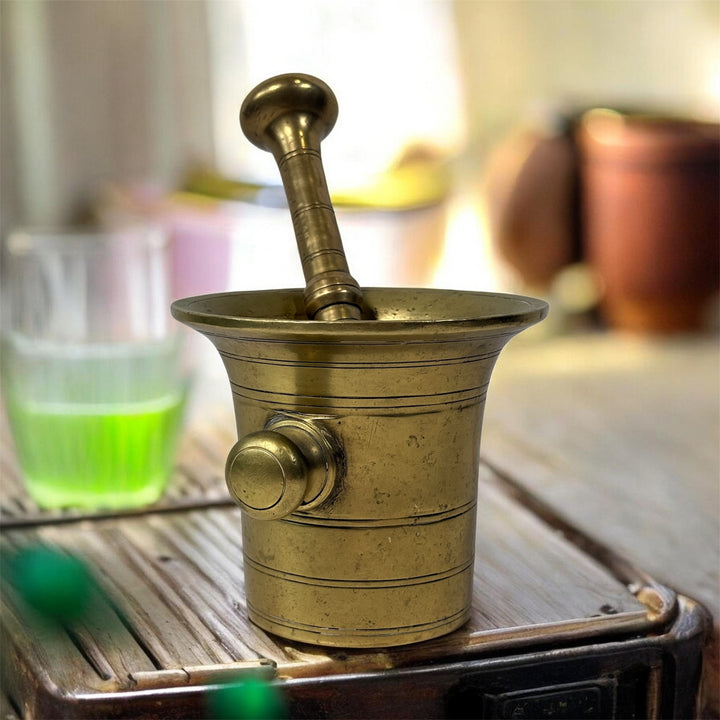 Vintage brass apothecary mortar and pestle, heavy cast with flared rim and rich patina. Classic pharmacy décor piece, functional and collectible.
