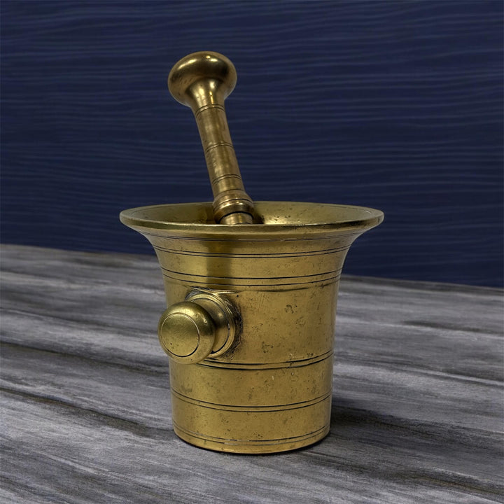 Vintage brass apothecary mortar and pestle, heavy cast with flared rim and rich patina. Classic pharmacy décor piece, functional and collectible.