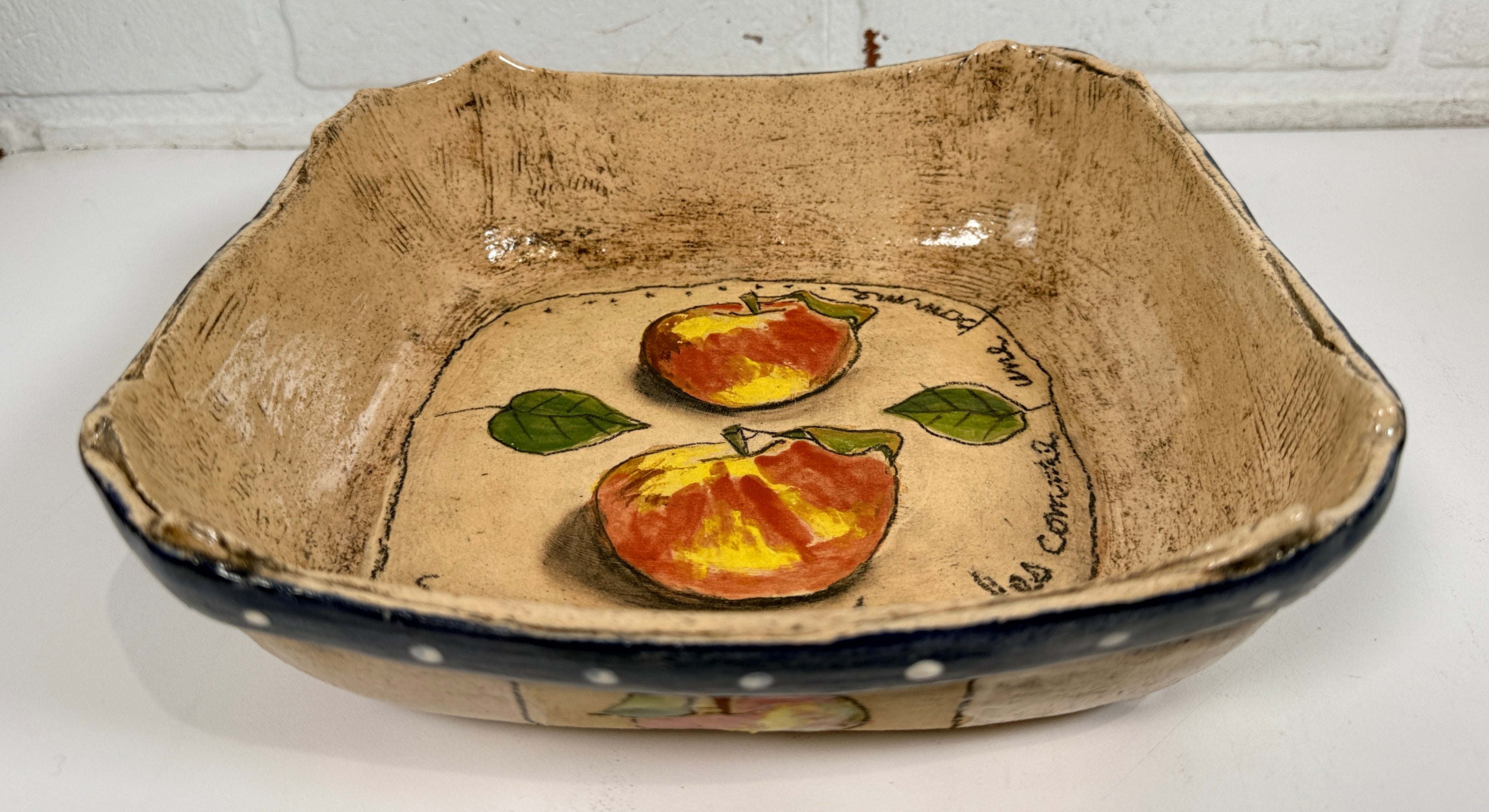Signed studio pottery apple bowl with rustic farmhouse style, hand-painted ceramic fruit bowl, decorative artisan serving dish.