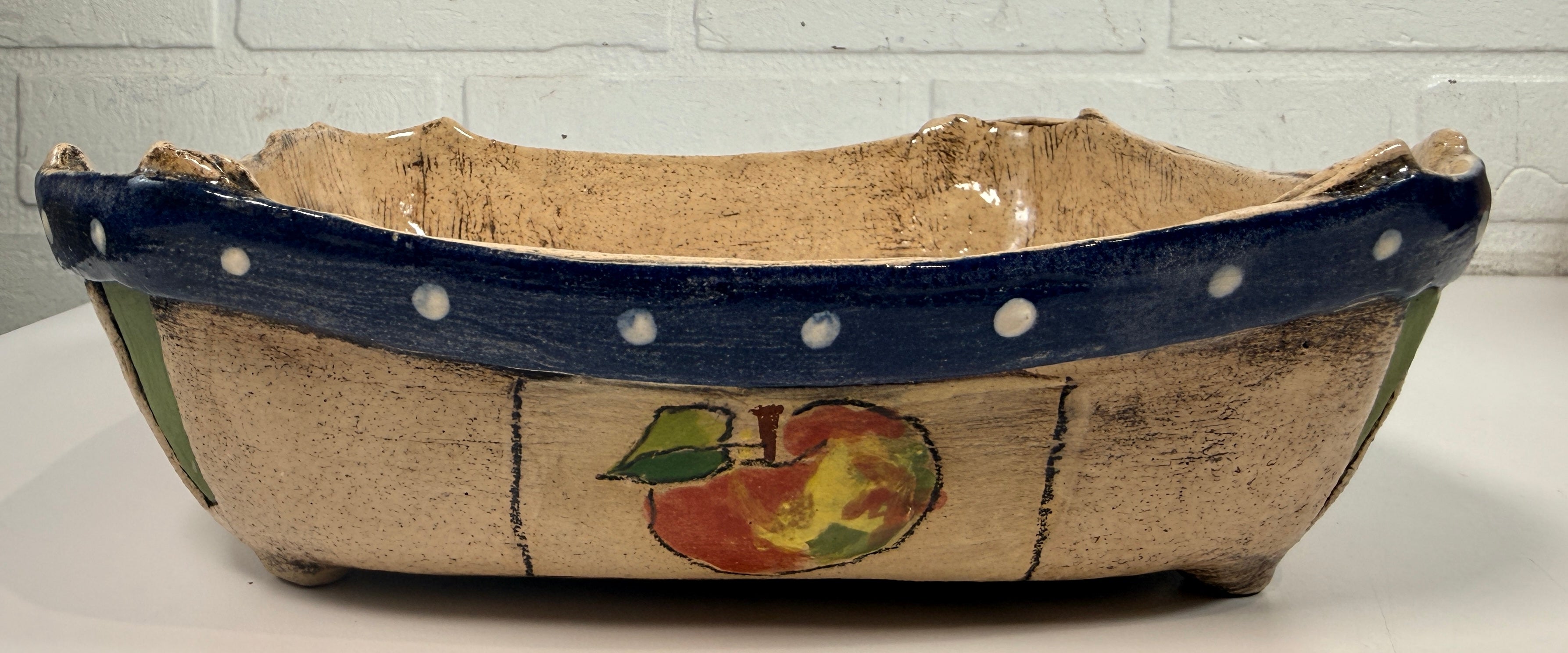 Signed studio pottery apple bowl with rustic farmhouse style, hand-painted ceramic fruit bowl, decorative artisan serving dish.
