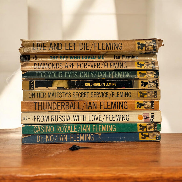 Vintage James Bond Ian Fleming paperback lot of 10 Pan Books editions with classic 007 cover art. Great collectible shelf display set for Bond fans.