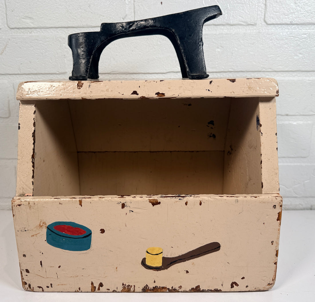 Vintage folk art shoe shine box with cast iron footrest handle. Rustic wooden cobbler caddy with hand-painted details, perfect for decor or storage.
