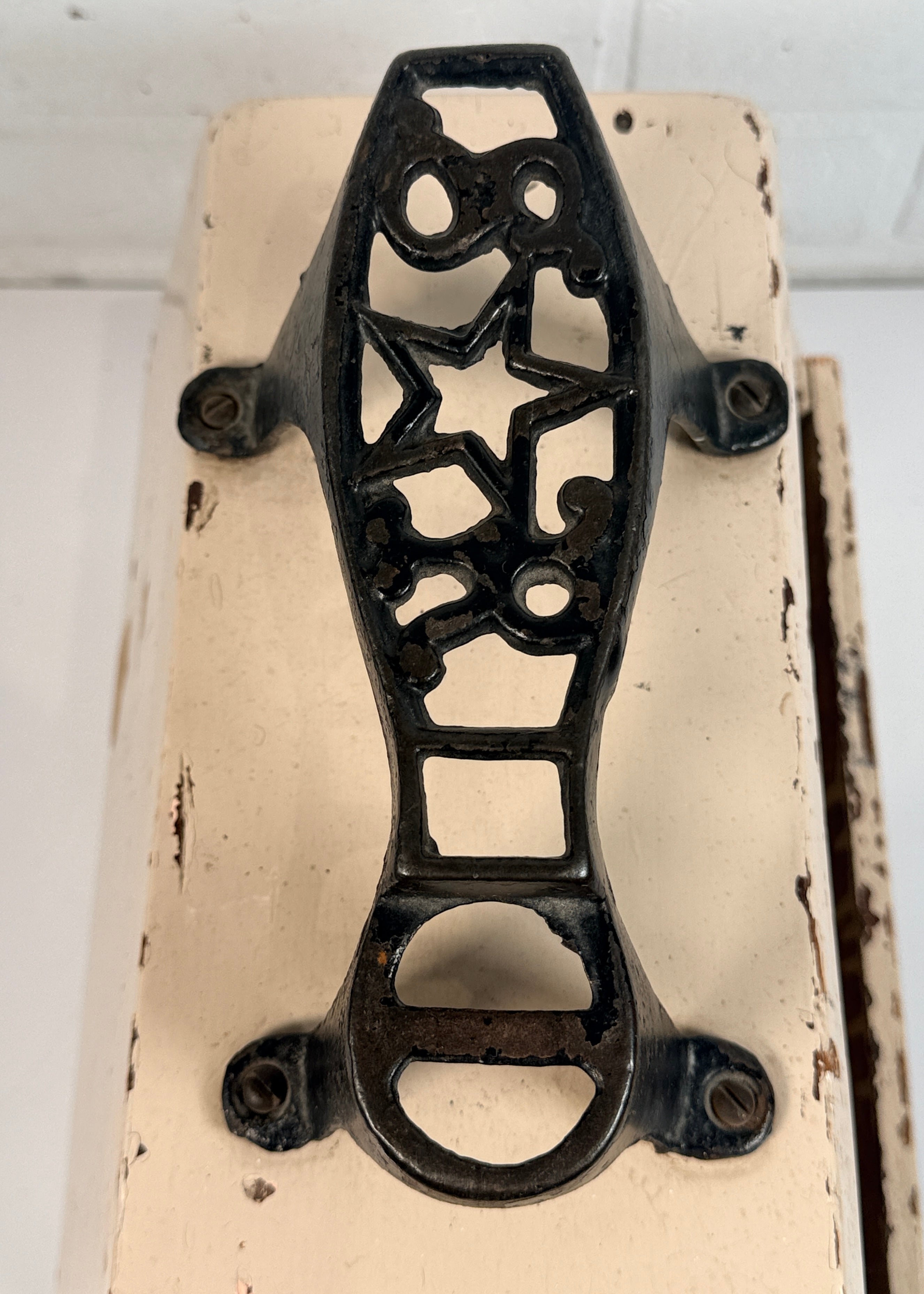 Vintage folk art shoe shine box with cast iron footrest handle. Rustic wooden cobbler caddy with hand-painted details, perfect for decor or storage.