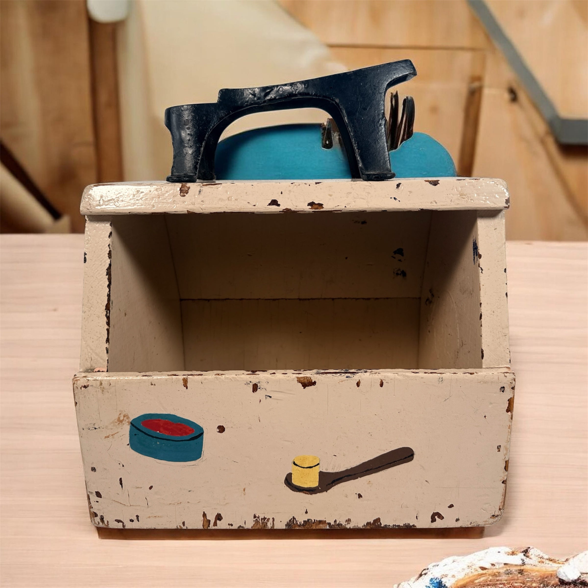 Vintage folk art shoe shine box with cast iron footrest handle. Rustic wooden cobbler caddy with hand-painted details, perfect for decor or storage.