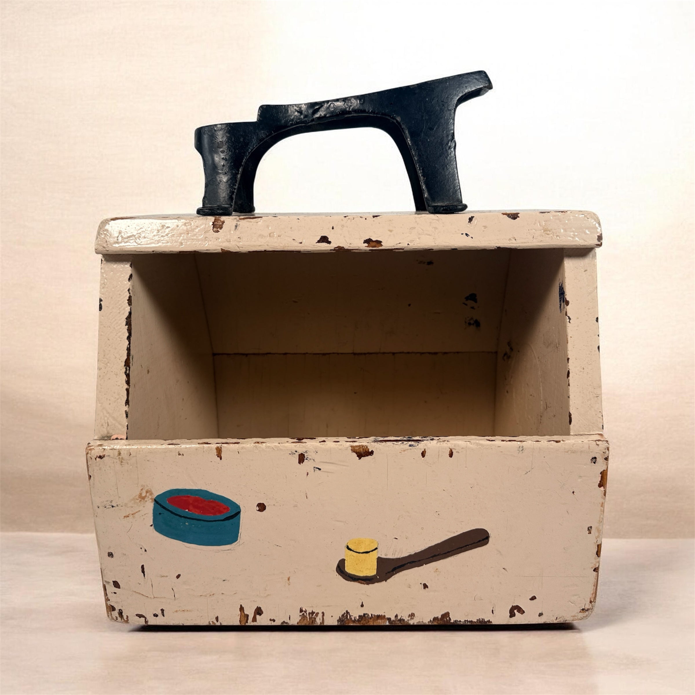 Vintage folk art shoe shine box with cast iron footrest handle. Rustic wooden cobbler caddy with hand-painted details, perfect for decor or storage.